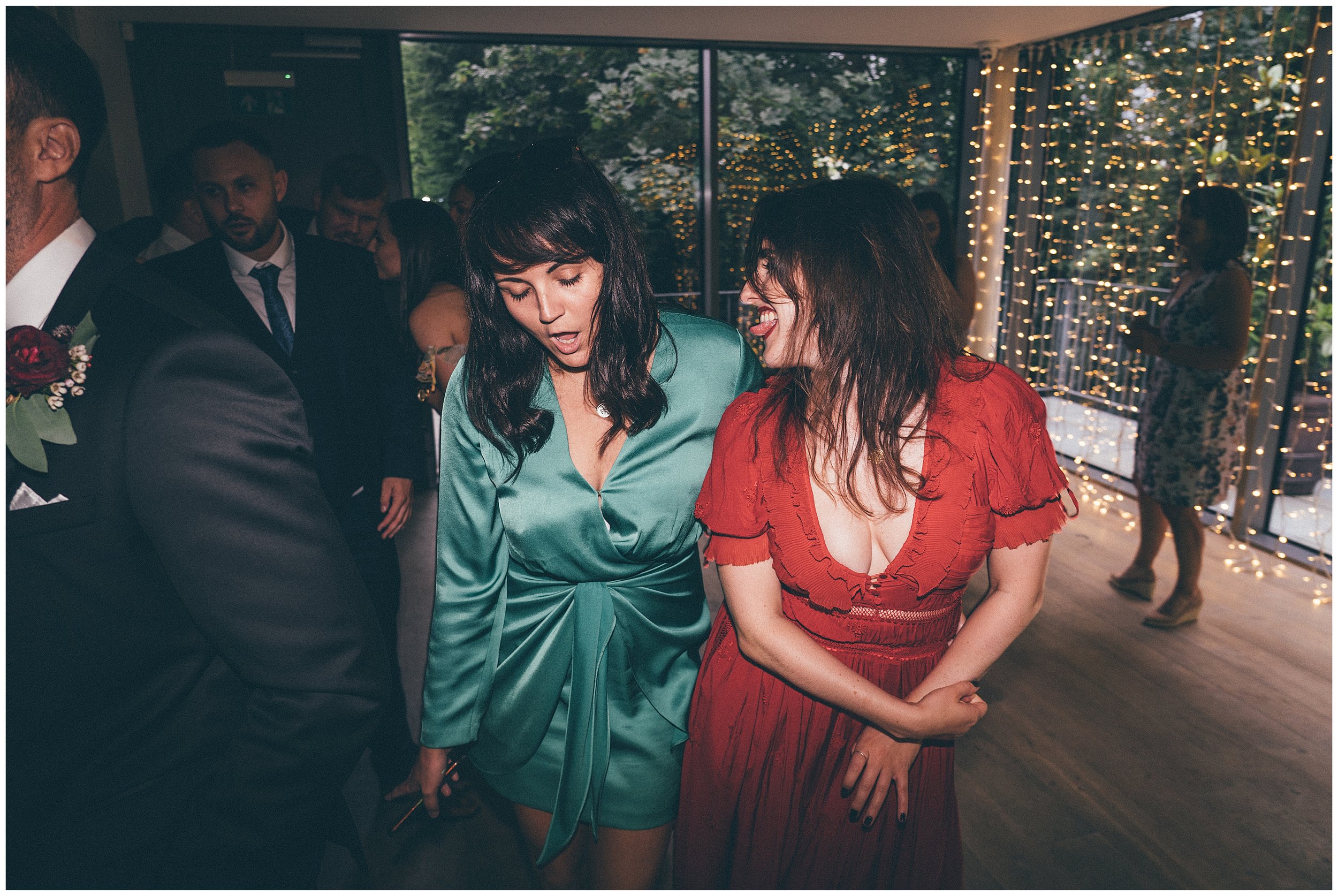 Two women dance at Old Palace wedding venue