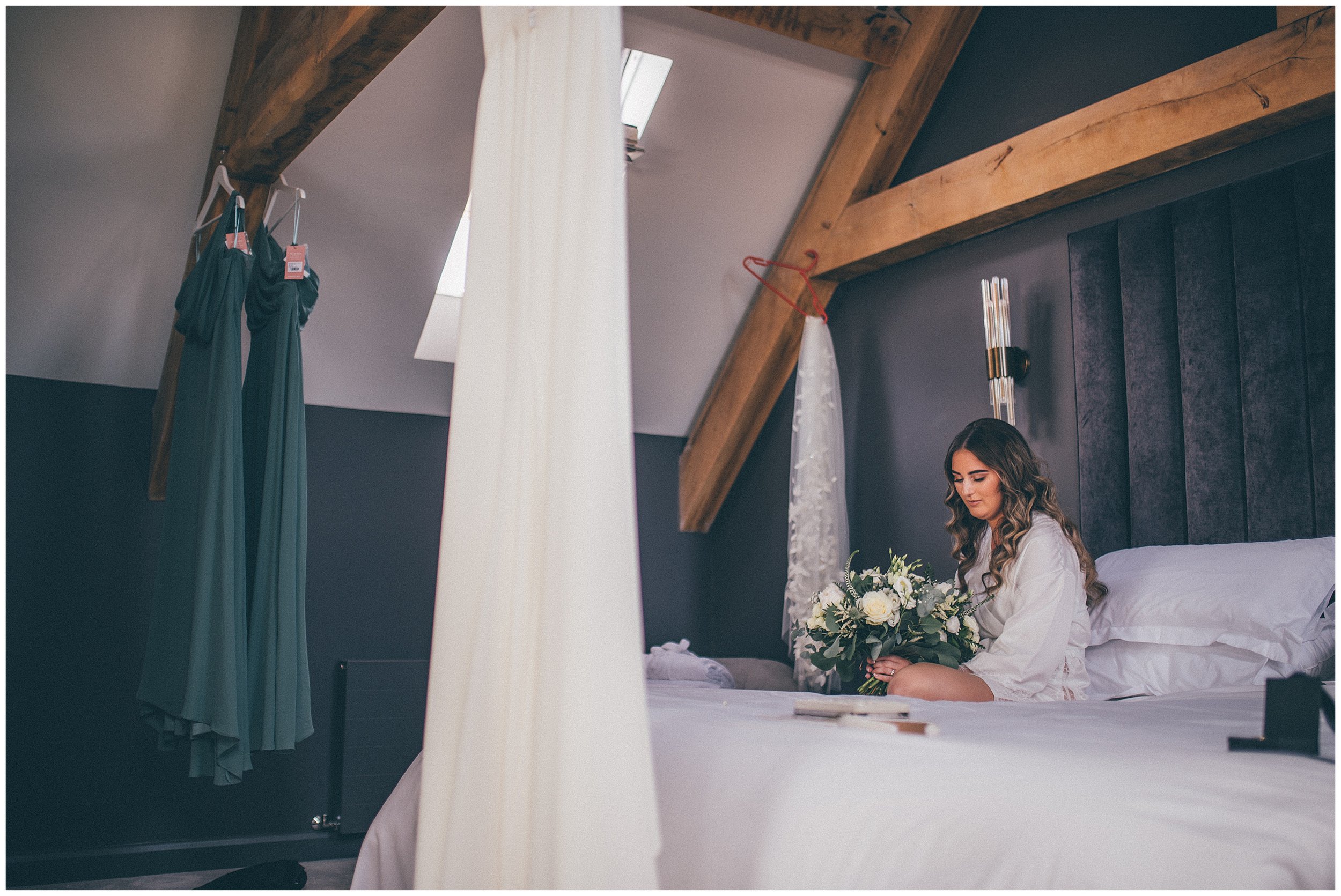 Bride looks at her beautiful wedding bouquet at the Oakwood at Ryther