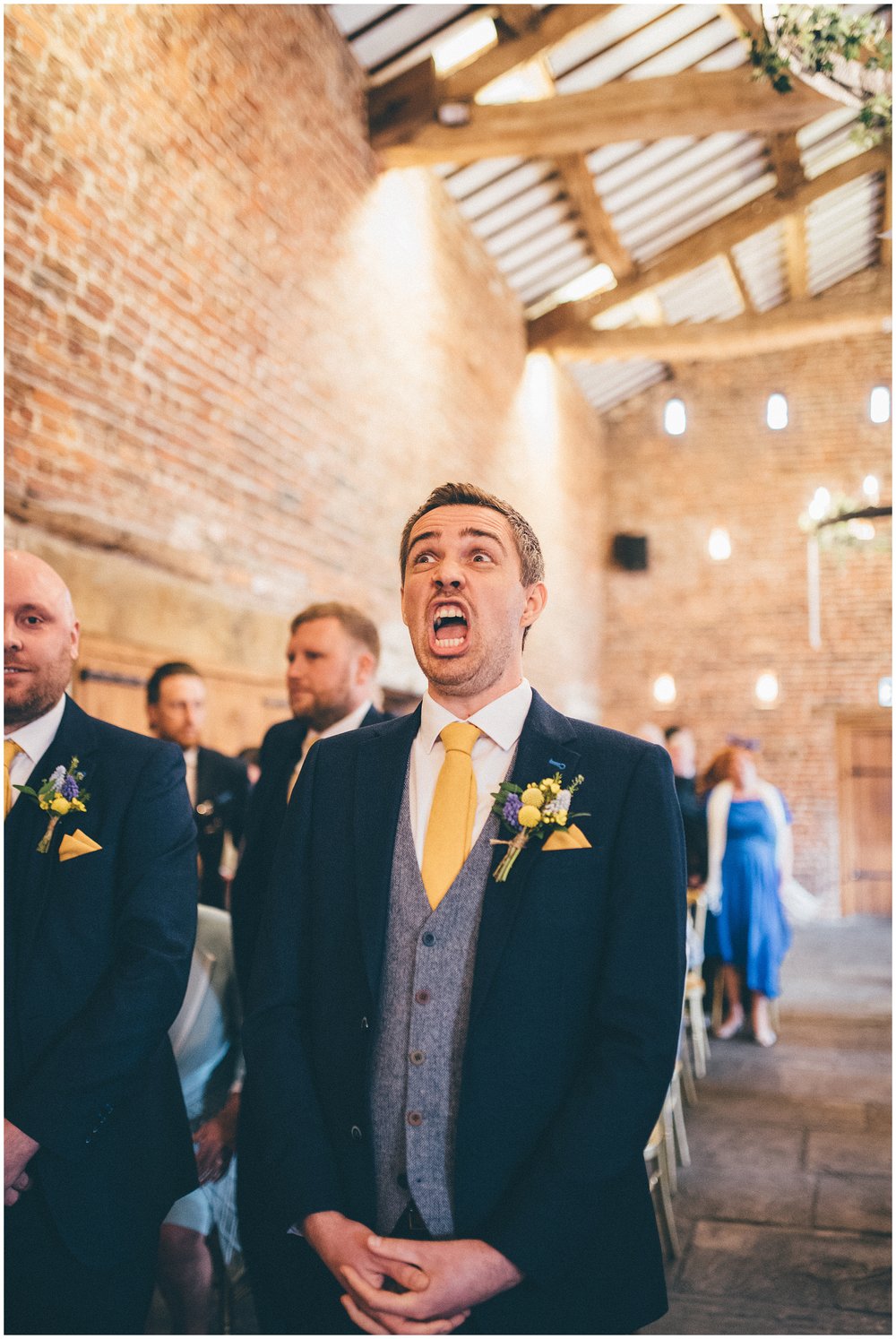 Nervous groom at the top of the aisle waiting for his bride at Meols Hall