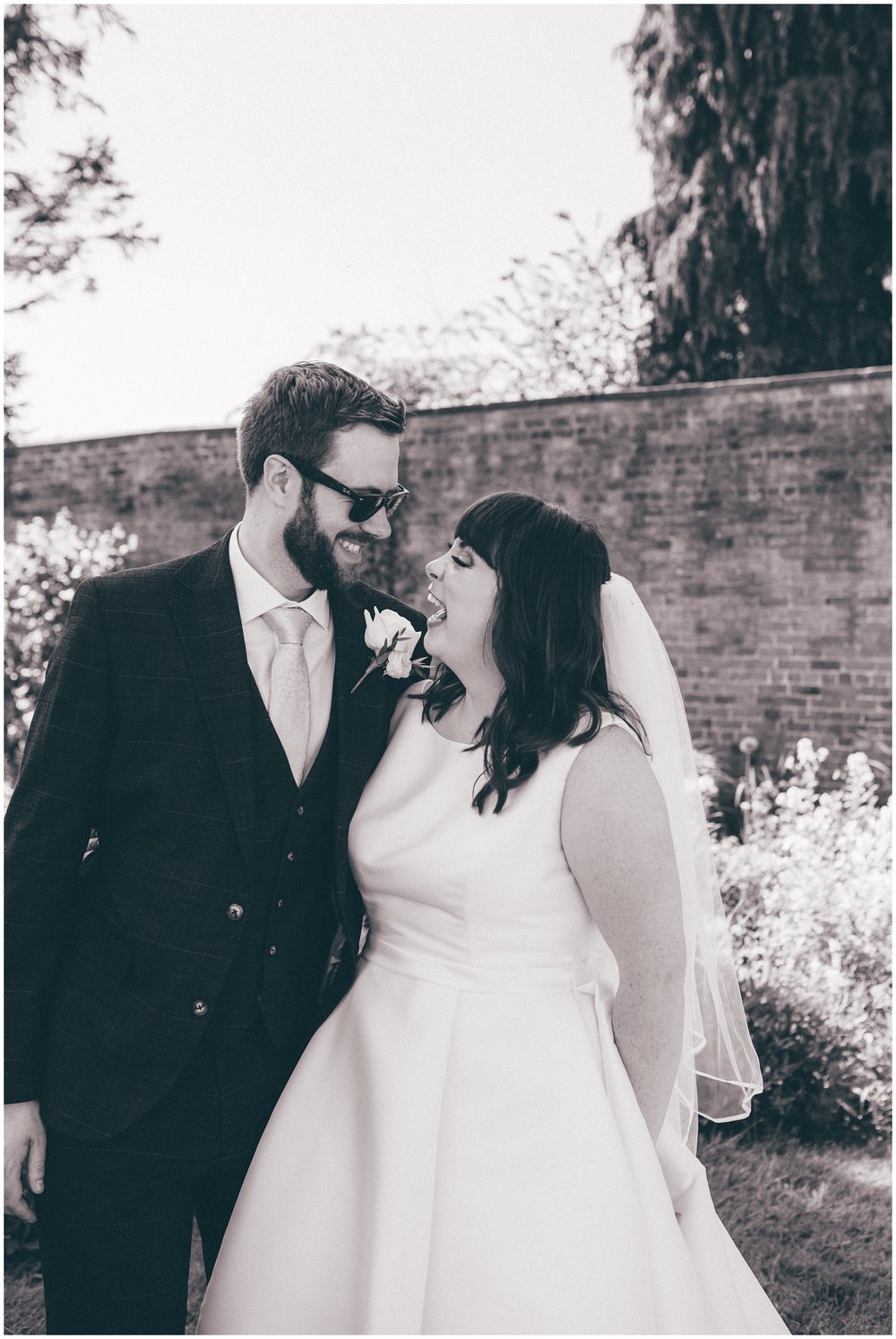 Groom wears sunglasses at Rowton Hall wedding in Cheshire