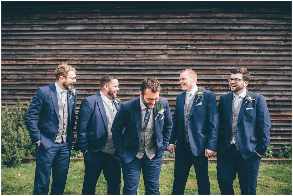 Groom and his groomsmen laugh together at Henham Barns