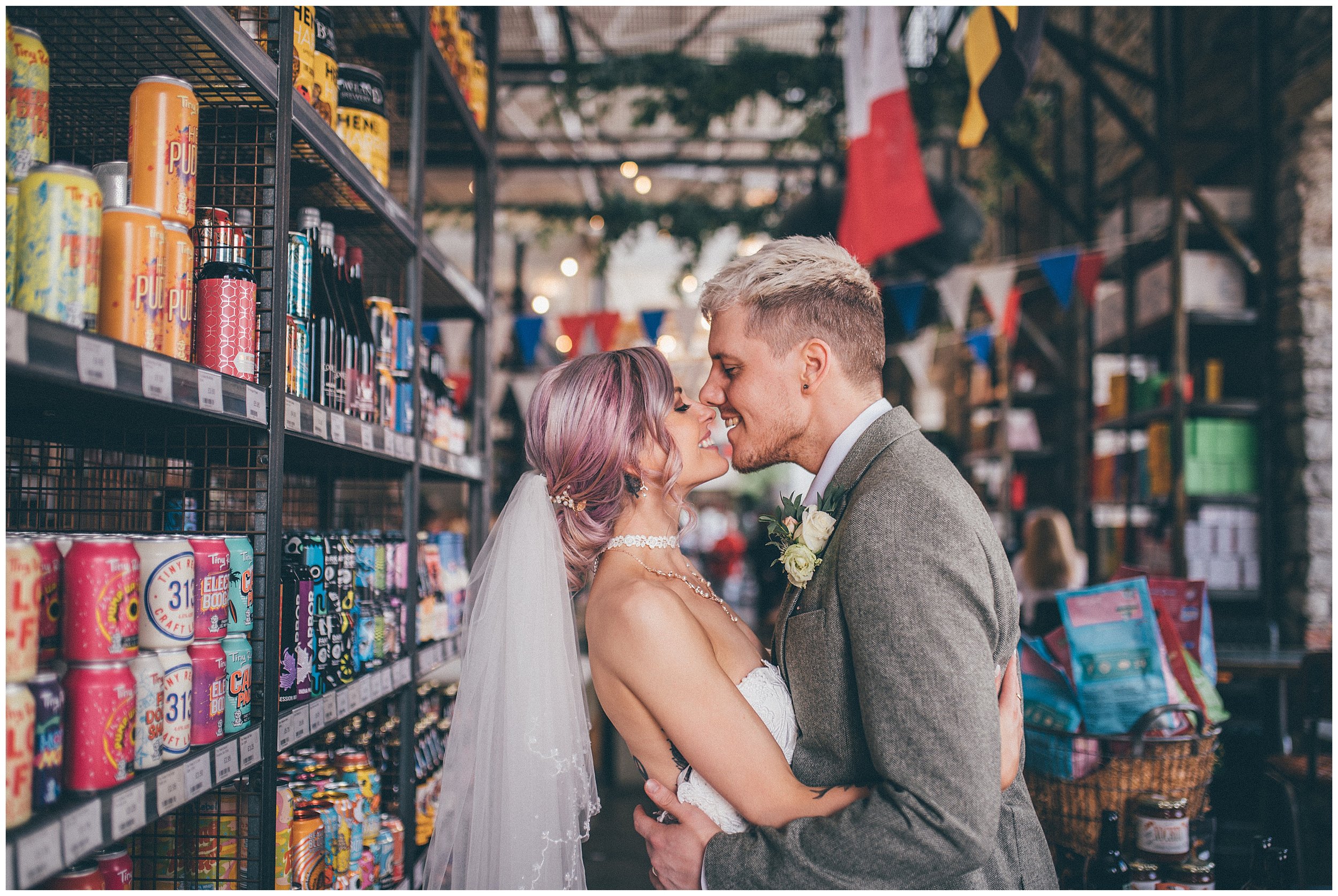 Newlyweds kiss in Bowland Brewery at Holmes Mill wedding venue