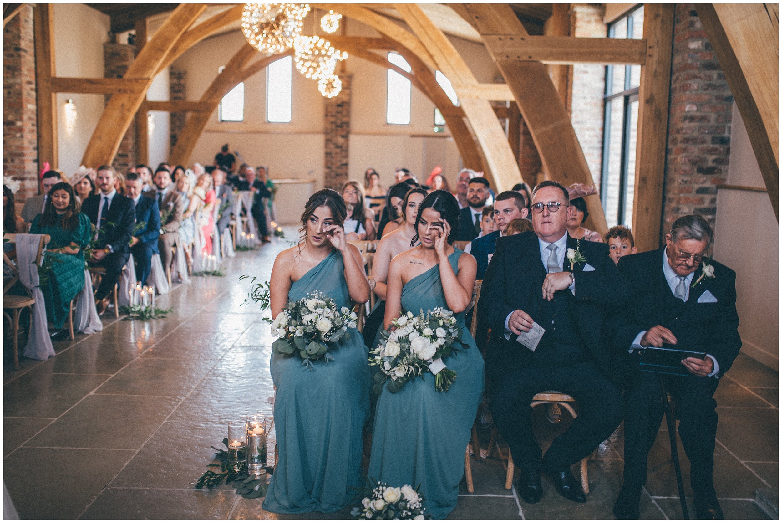 Bridesmaids cry at the bride and groom get married at Oakwood at Ryther