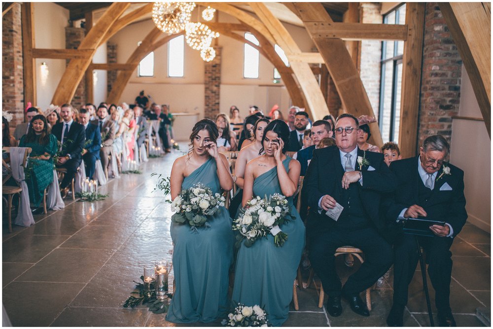 Bridesmaids cry at the bride and groom get married at Oakwood at Ryther