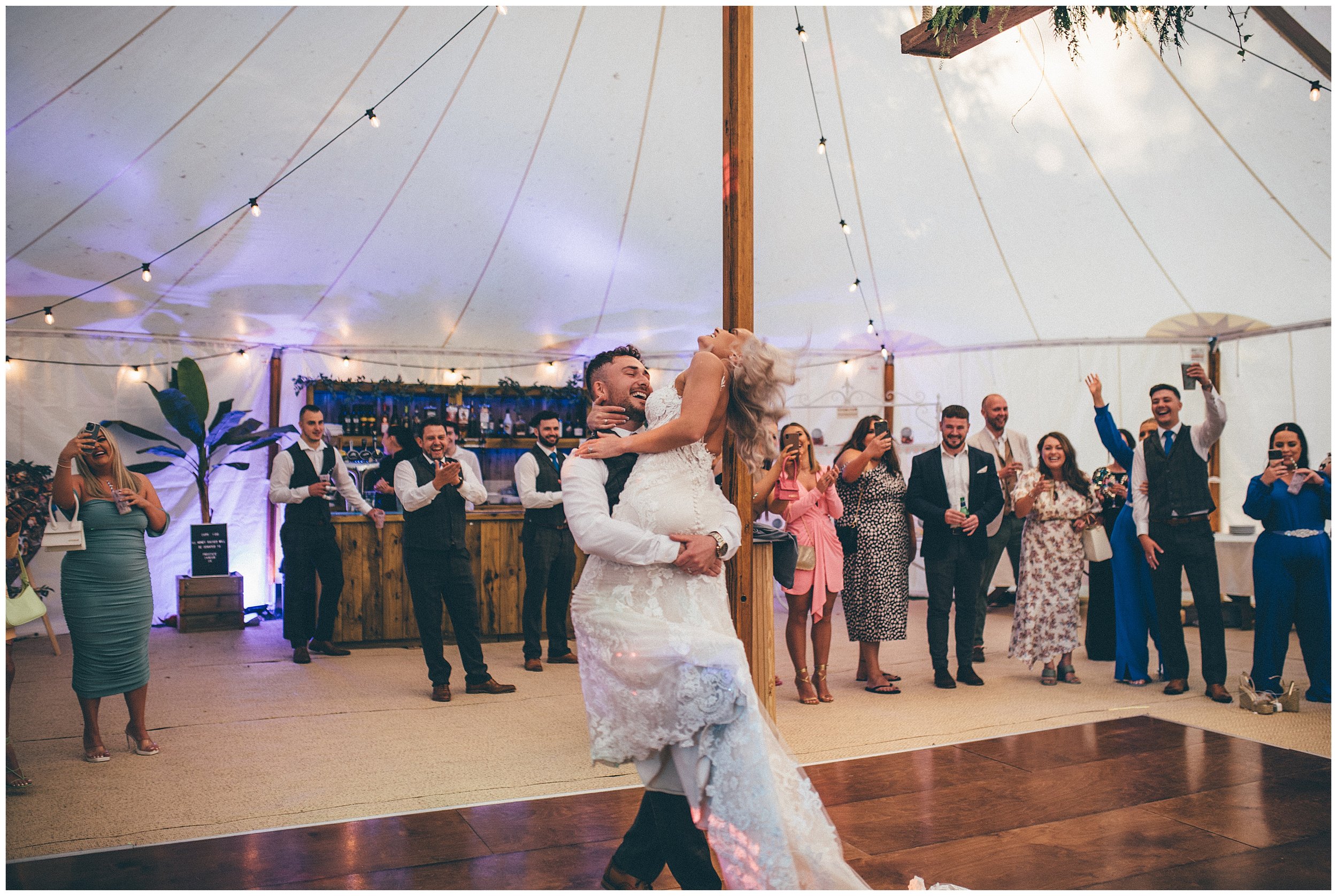 Groom swings his bride around at Bodryhddan Hall