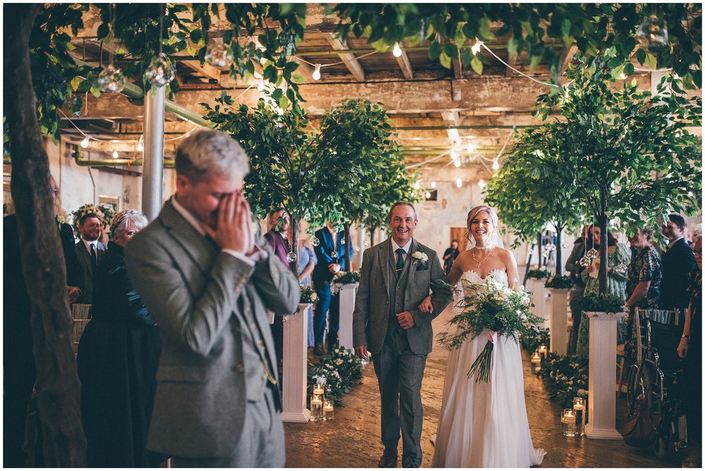 Groom cries as his bride walks down the aisle at Holmes Mill wedding venue