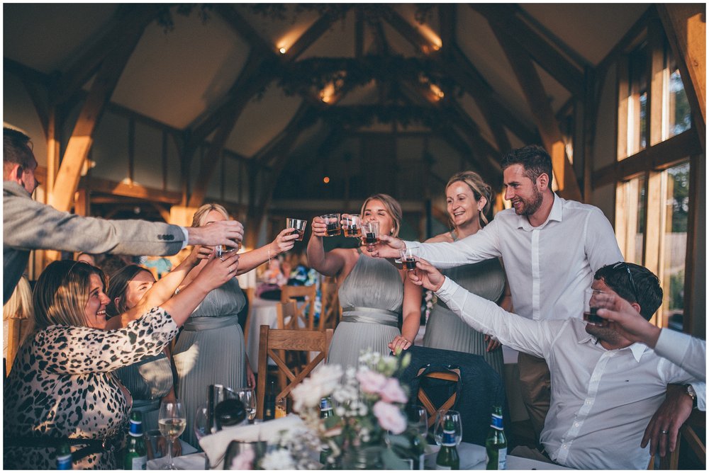 Wedding guests do shots at Tower Hill Barns wedding