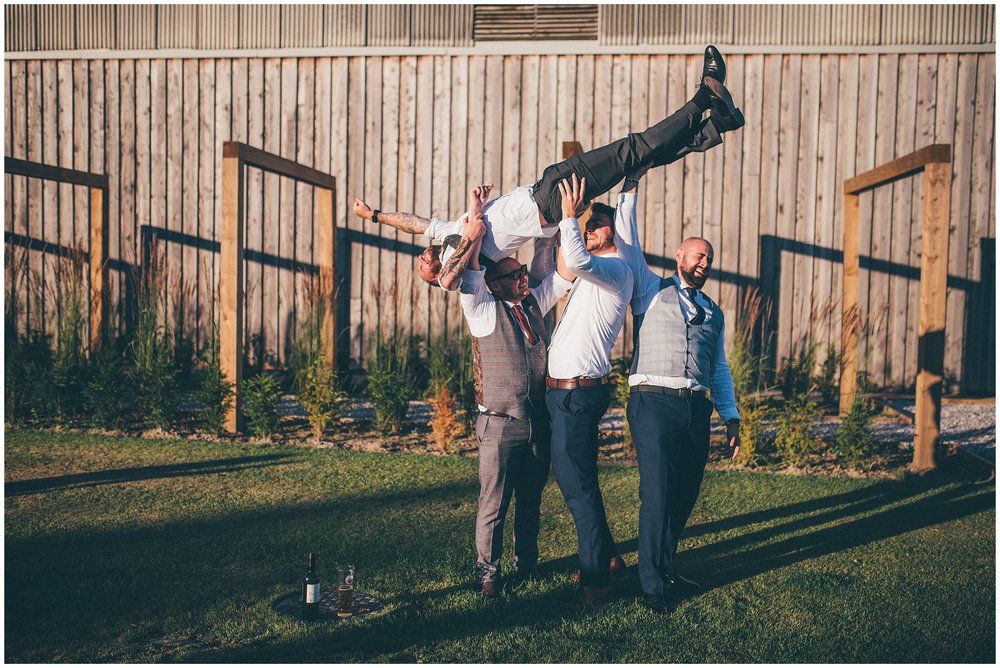 Guest gets lifted up in the air at Oakwood at Ryther wedding