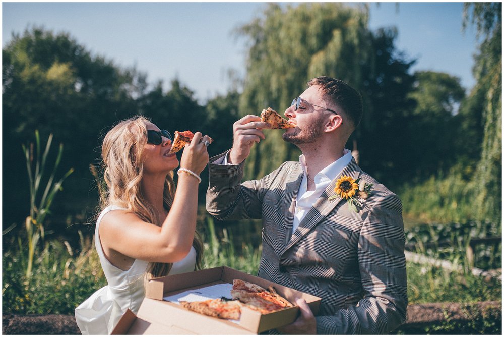 Bride and groom eat pizza at relaxed Cheshire garden wedding