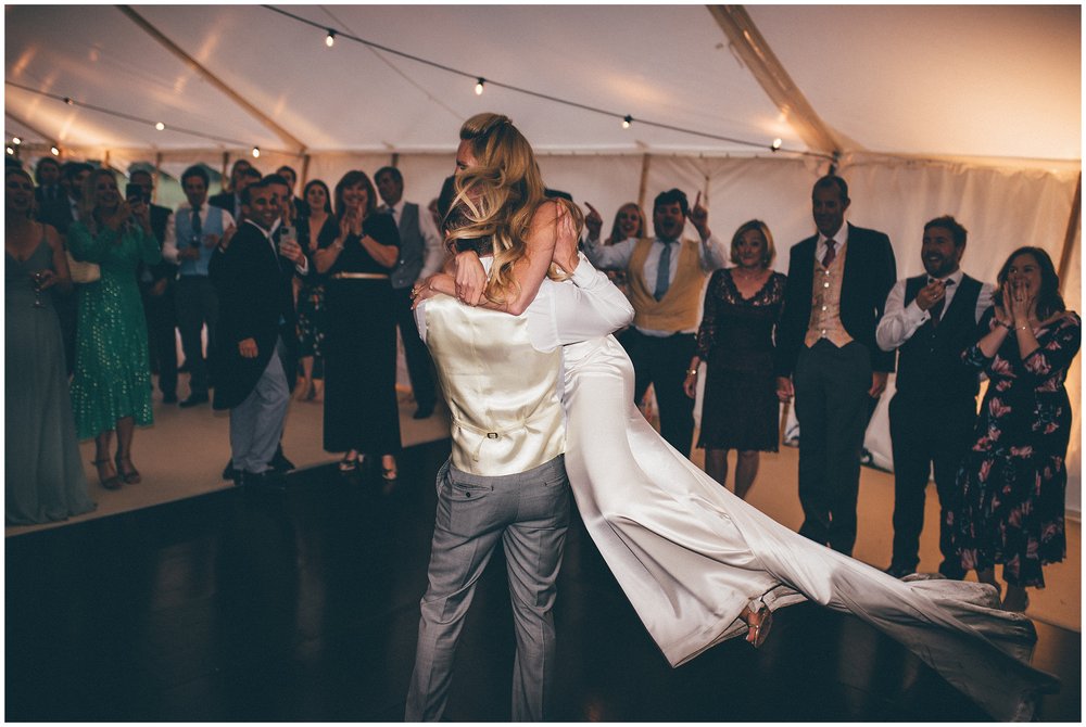 Groom swings his bride around during their first dance at Cheshire wedding
