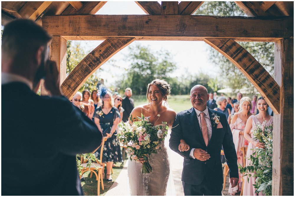 Bride walks down with the aisle with her dad to her crying groom at Skipbridge Country Wedding venue