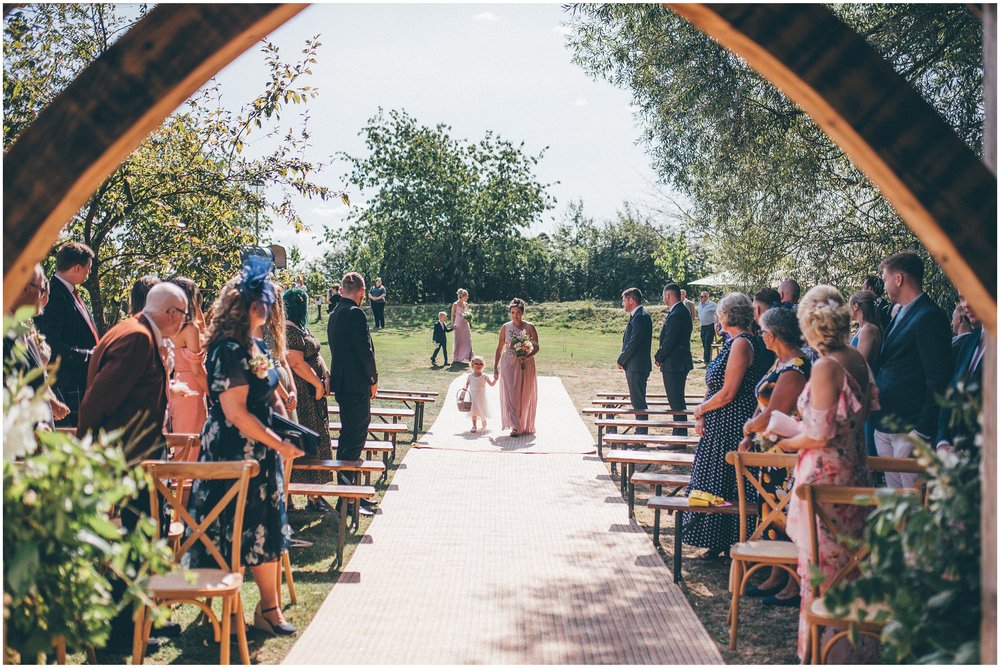 Bridesmaids walk down the aisle at Skipbridge Country Wedding venue in Yorkshire