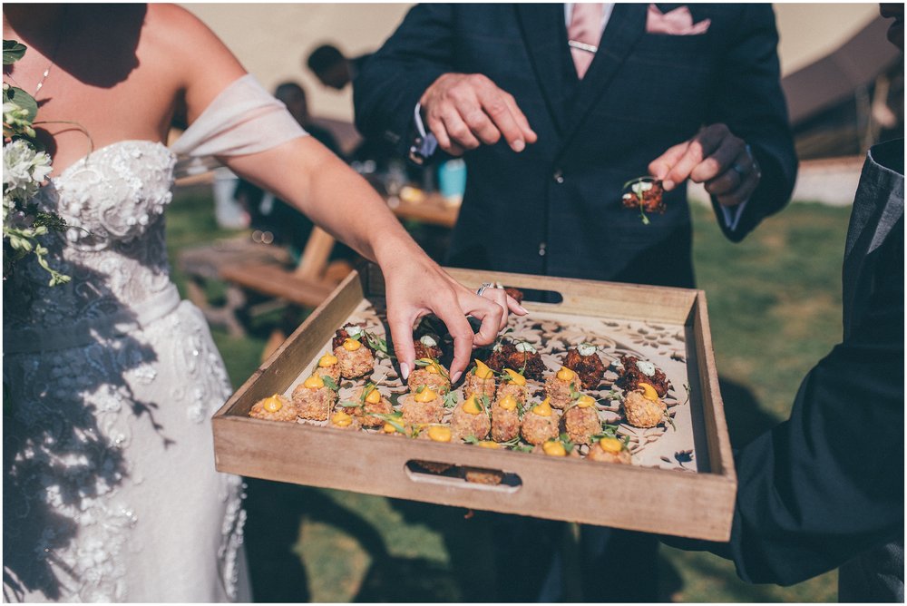 Bride and groom have canapés at Skipbridge Country Wedding venue in Yorkshire