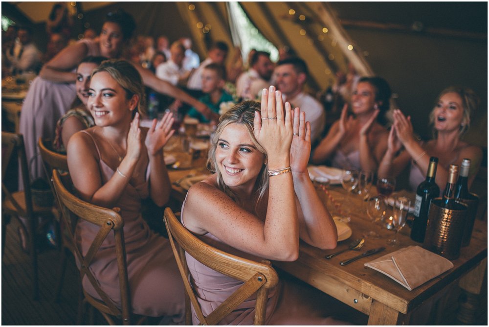 Wedding guests applaud the bride and groom coming into their wedding breakfast at Skipbridge Country Wedding venue in Yorkshire
