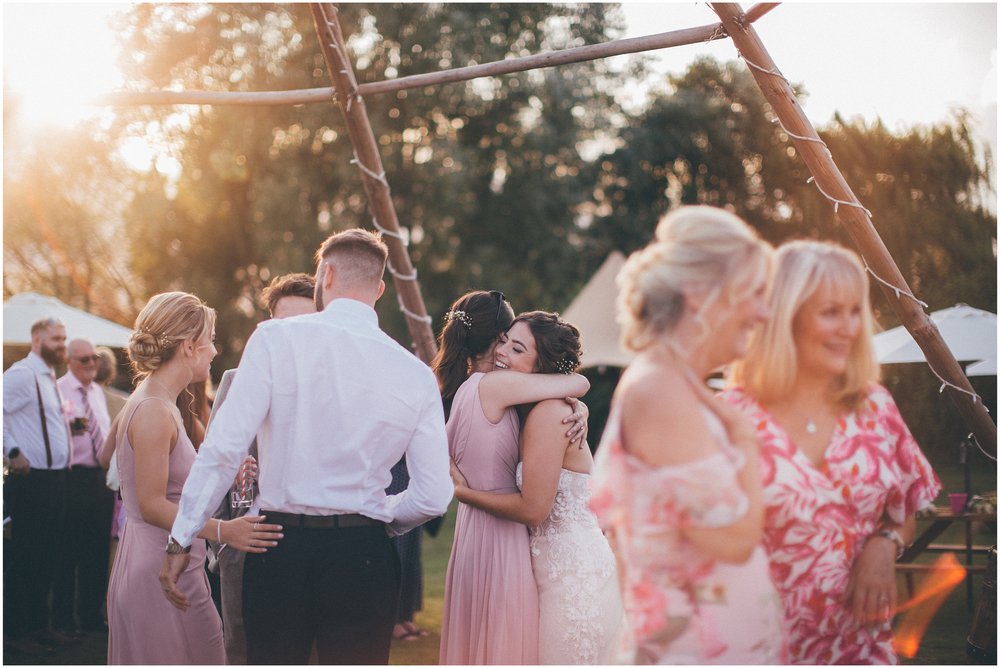 Wedding guests join the bride and groom and dance outside in the sun at Skipbridge Country wedding venue in Yorkshire