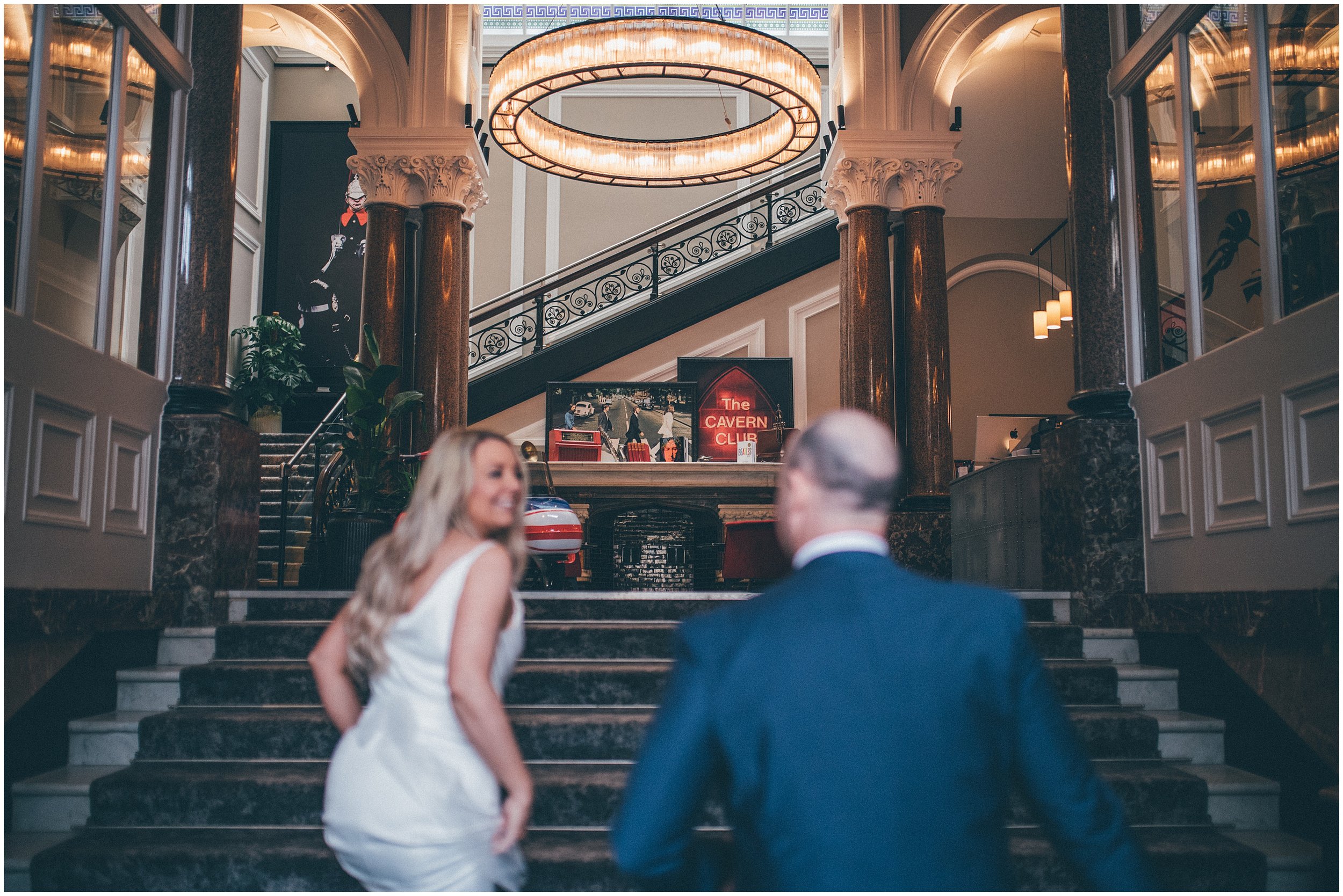 Bride and groom walk back to Radisson Red hotel after their elopement in Liverpool city centre at St George's Hall in Liverpool