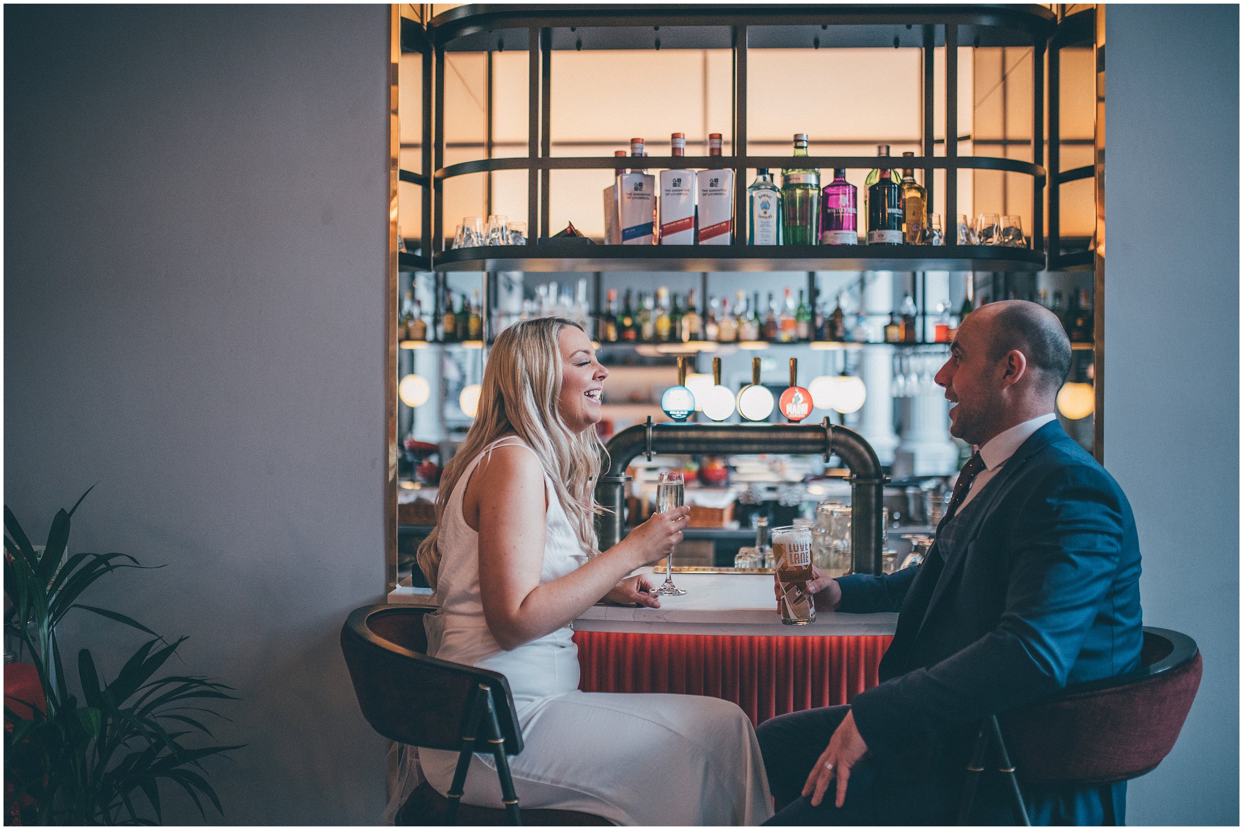 Bride and groom have a celebratory drink at Radisson Red after their elopement at St George's Hall in Liverpool City Centre