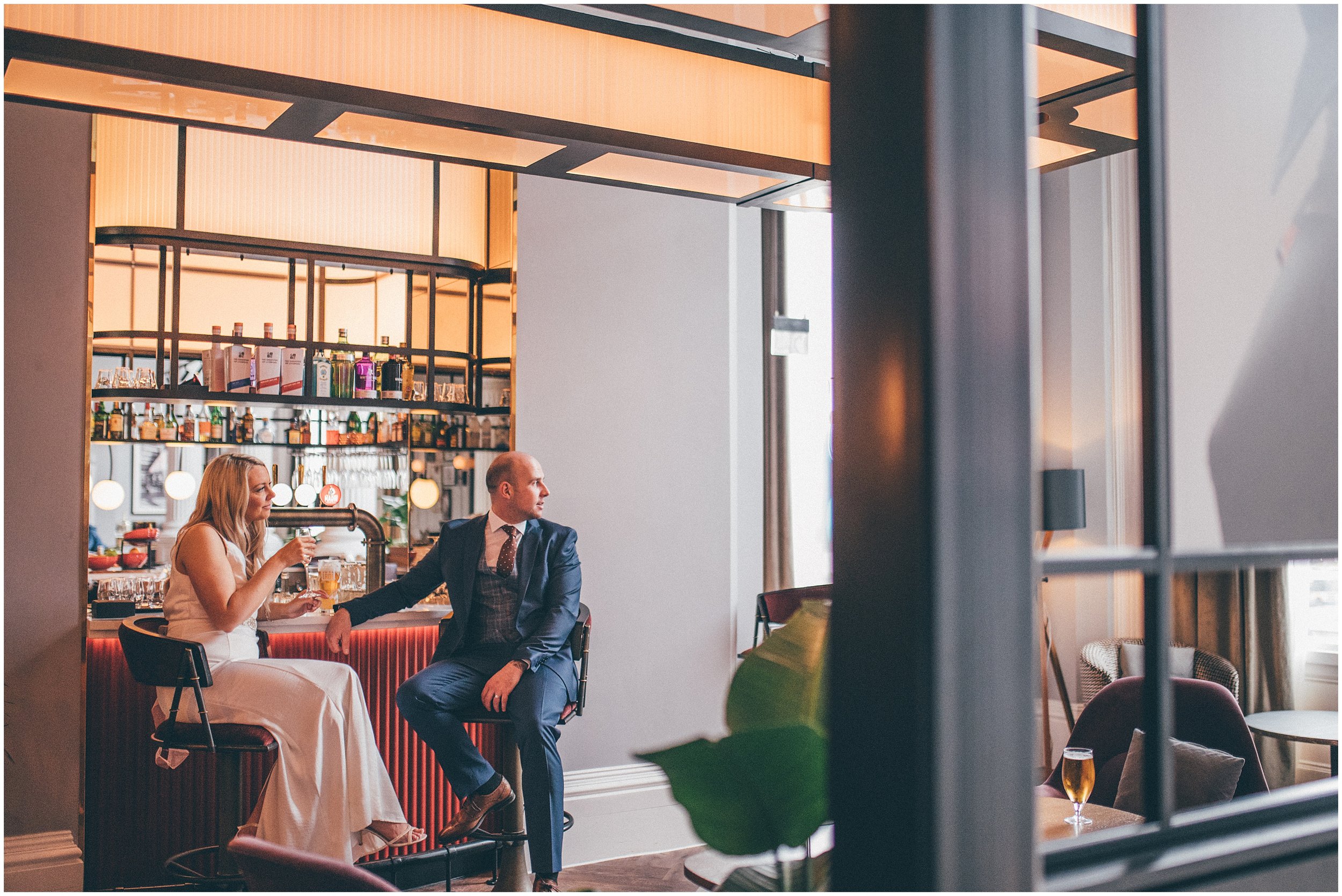 Bride and groom have a celebratory drink at Radisson Red after their elopement at St George's Hall in Liverpool City Centre