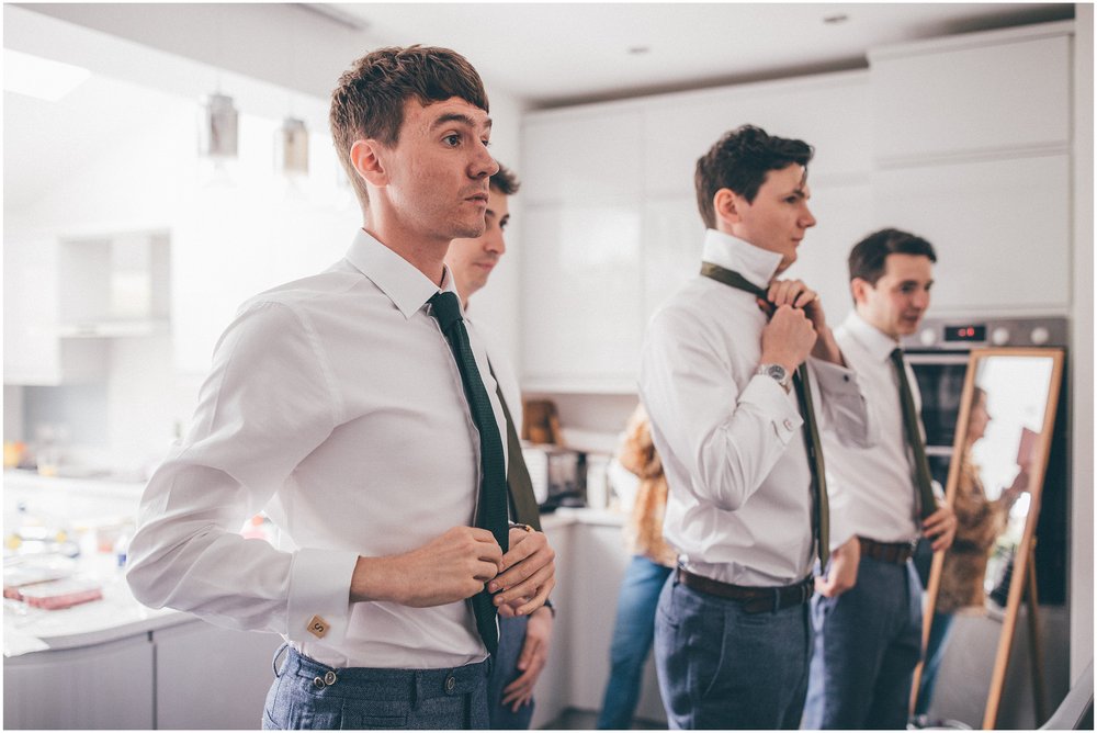 Groom and his groomsmen getting ready before the summer wedding at Sefton Palm House in Liverpool