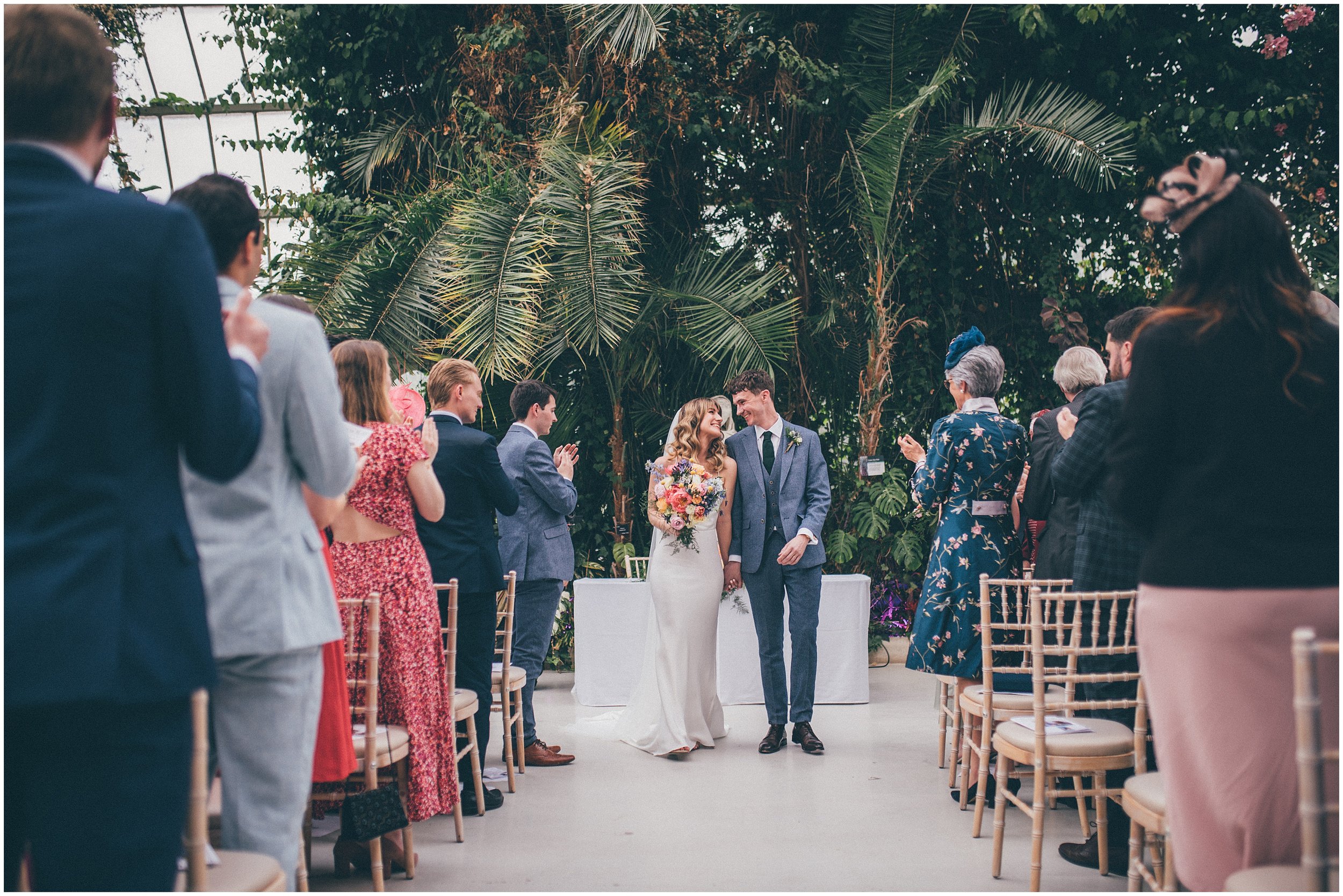 Bride and groom on their wedding day inside Sefton Palm House in Liverpool.