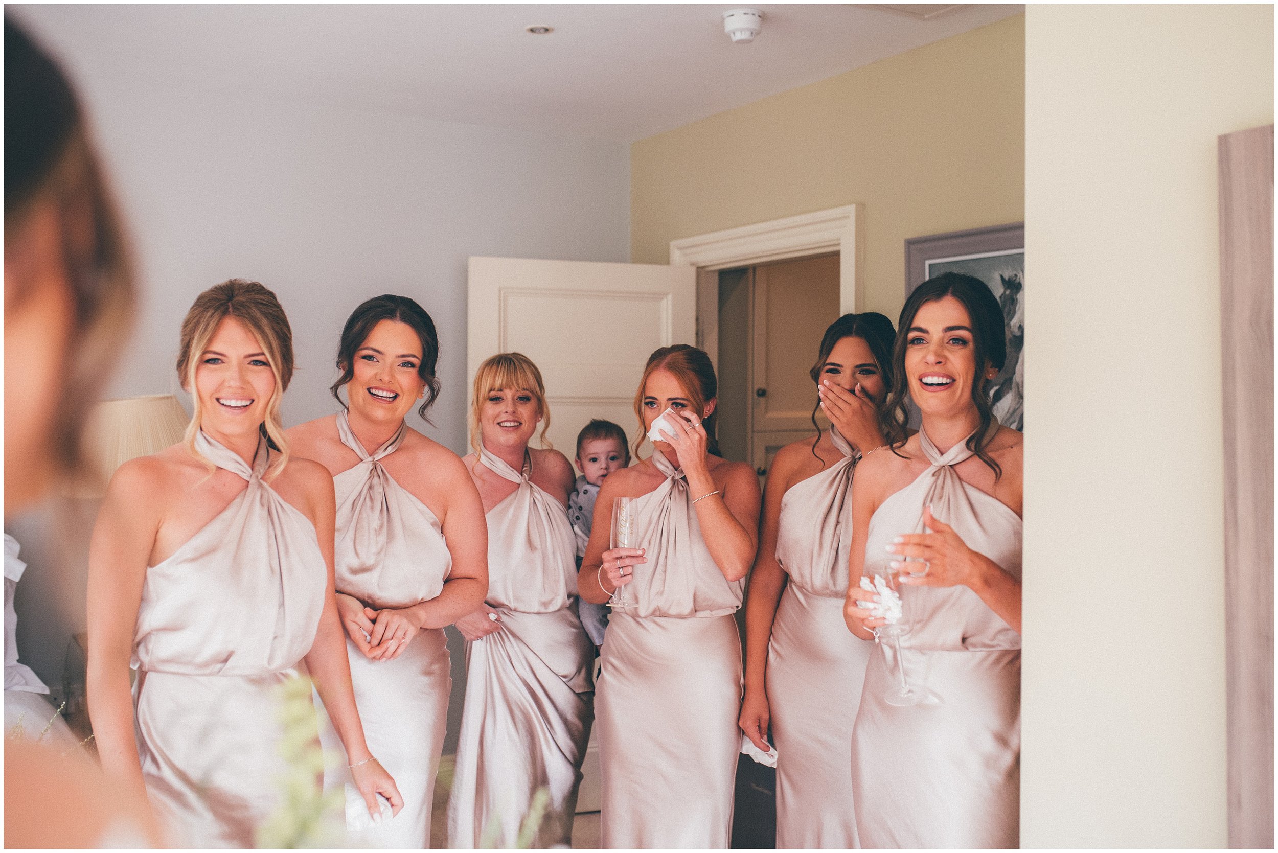 Bridesmaids have a first look with the bride in her wedding dress at Abbeywood Estate  in Delamere, Cheshire