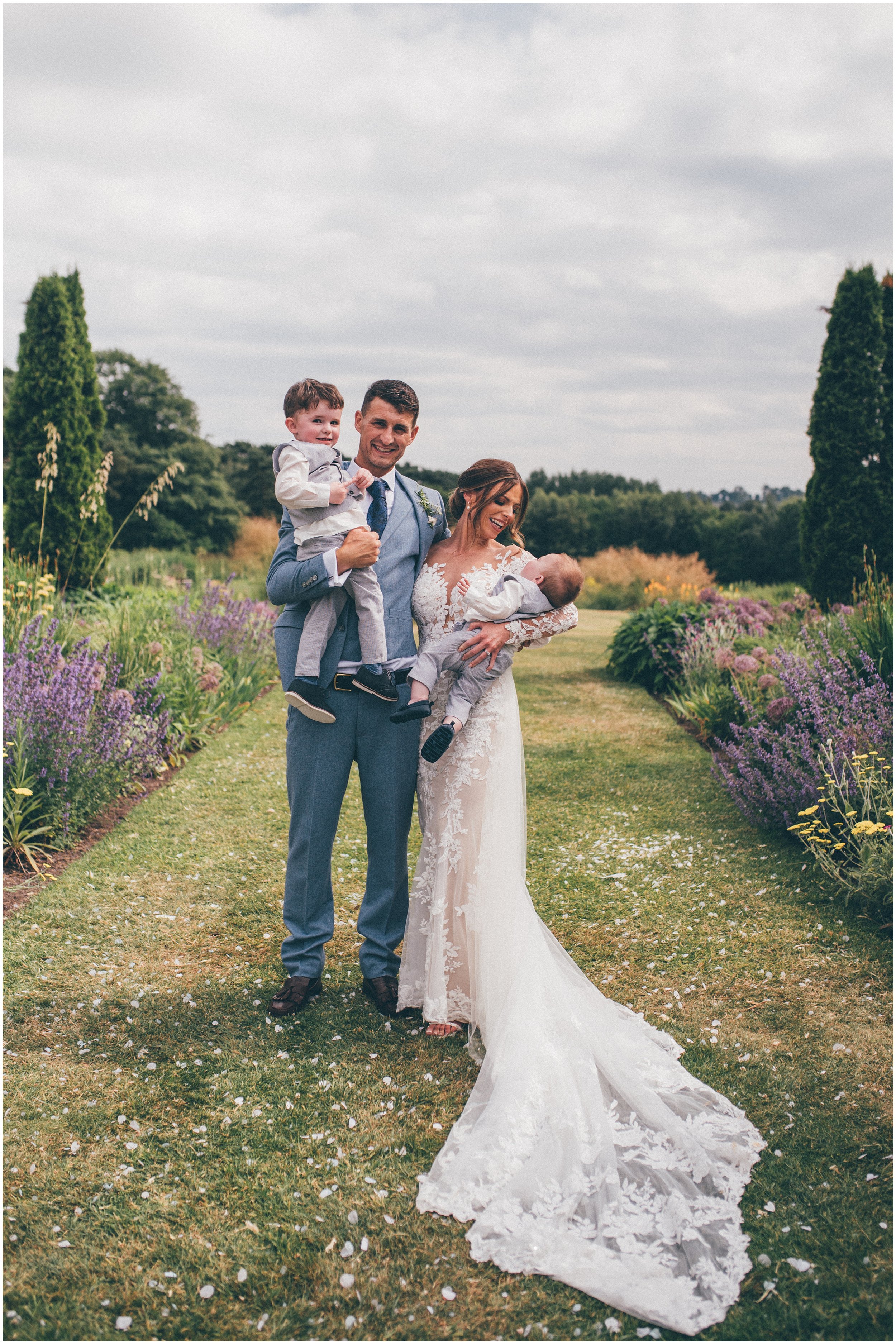 Beautiful bride and her family enjoy the pretty gardens at Abbeywood Estate in Delamere, Cheshire.