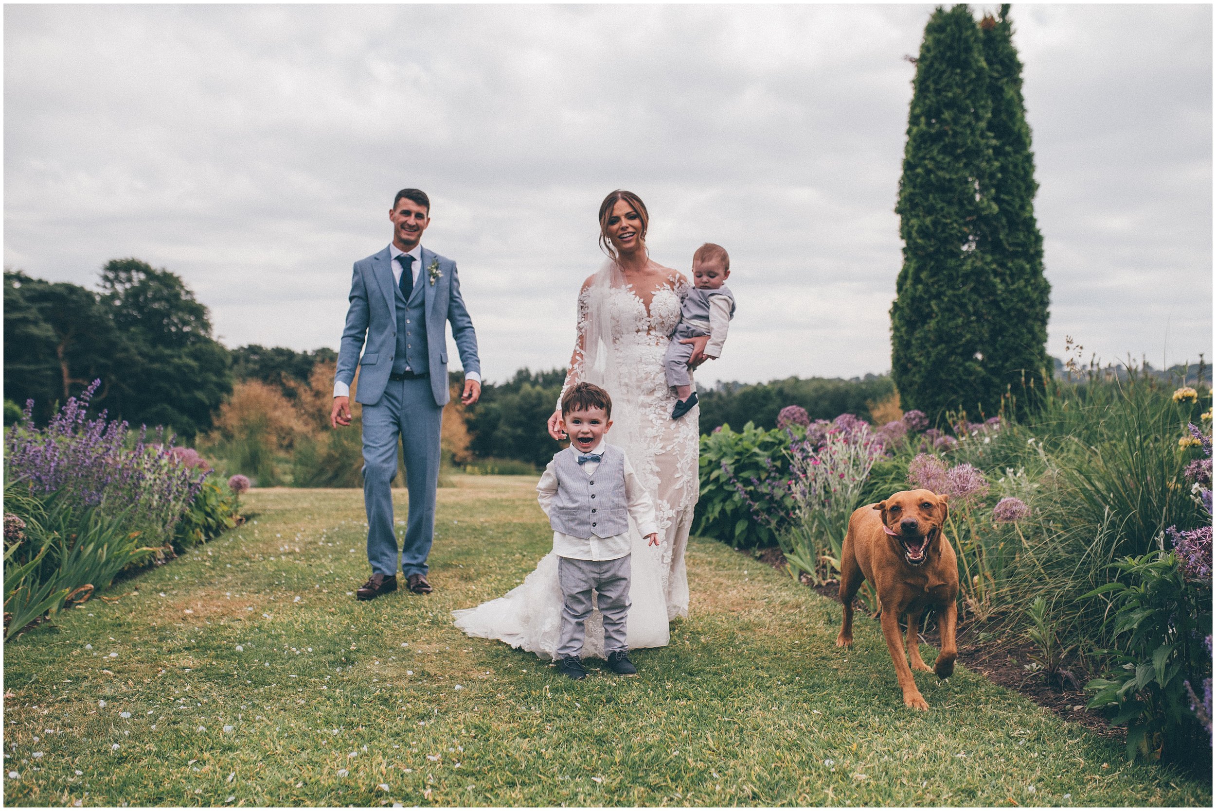 Beautiful bride and her family enjoy the pretty gardens at Abbeywood Estate in Delamere, Cheshire.