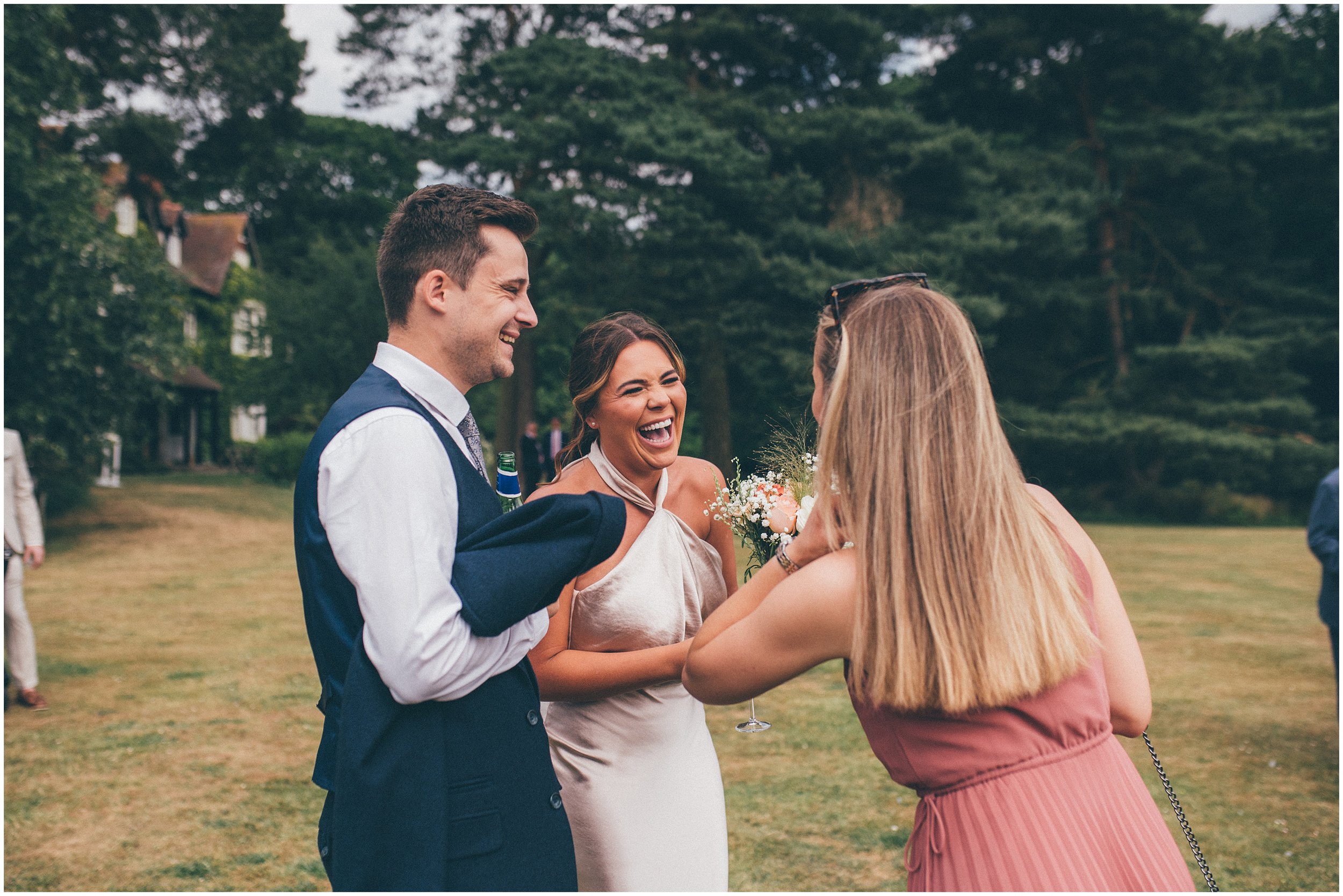 Wedding guests enjoy the beautiful gardens at Abbeywood Estate in Delamere, Cheshire for a summer wedding reception.