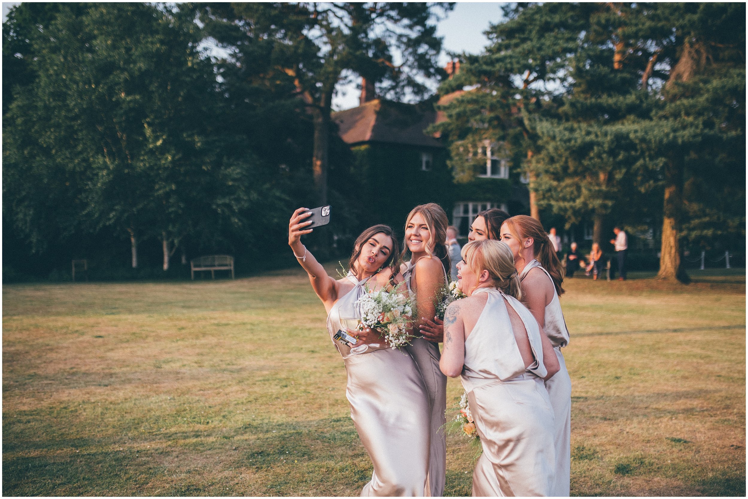 Bridal party enjoy golden hour at Abbeywood Estate wedding venue in Delamere, Cheshire.