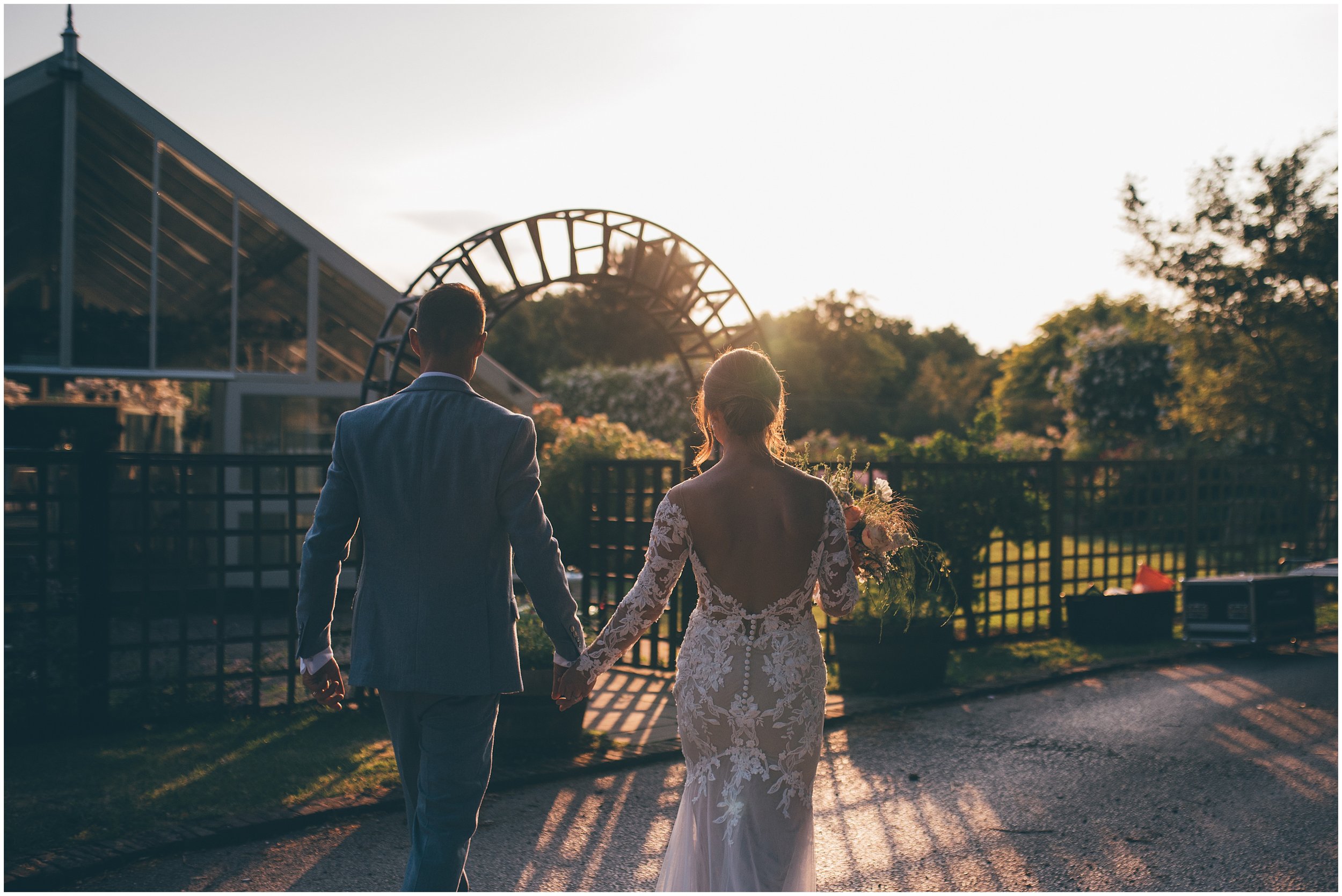 New husband and wife have portraits taken during golden hour at their wedding venue with the wedding photographer, Helen Jane Smiddy Photography.