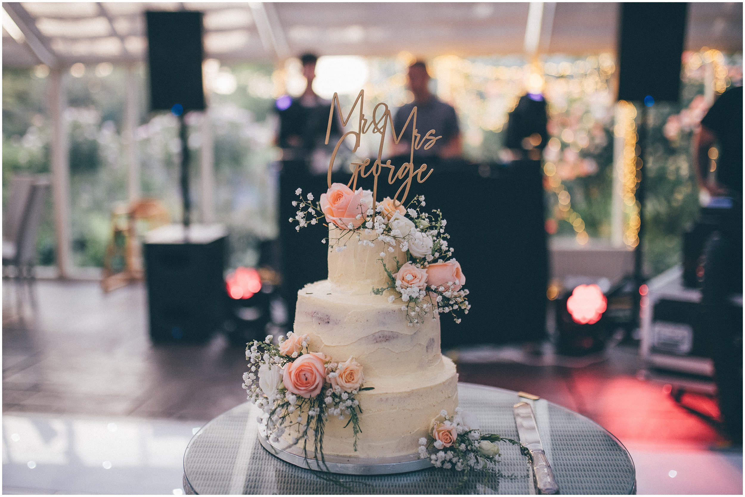 Wedding cake covered in flowers at Abbeywood estate wedding in Cheshire