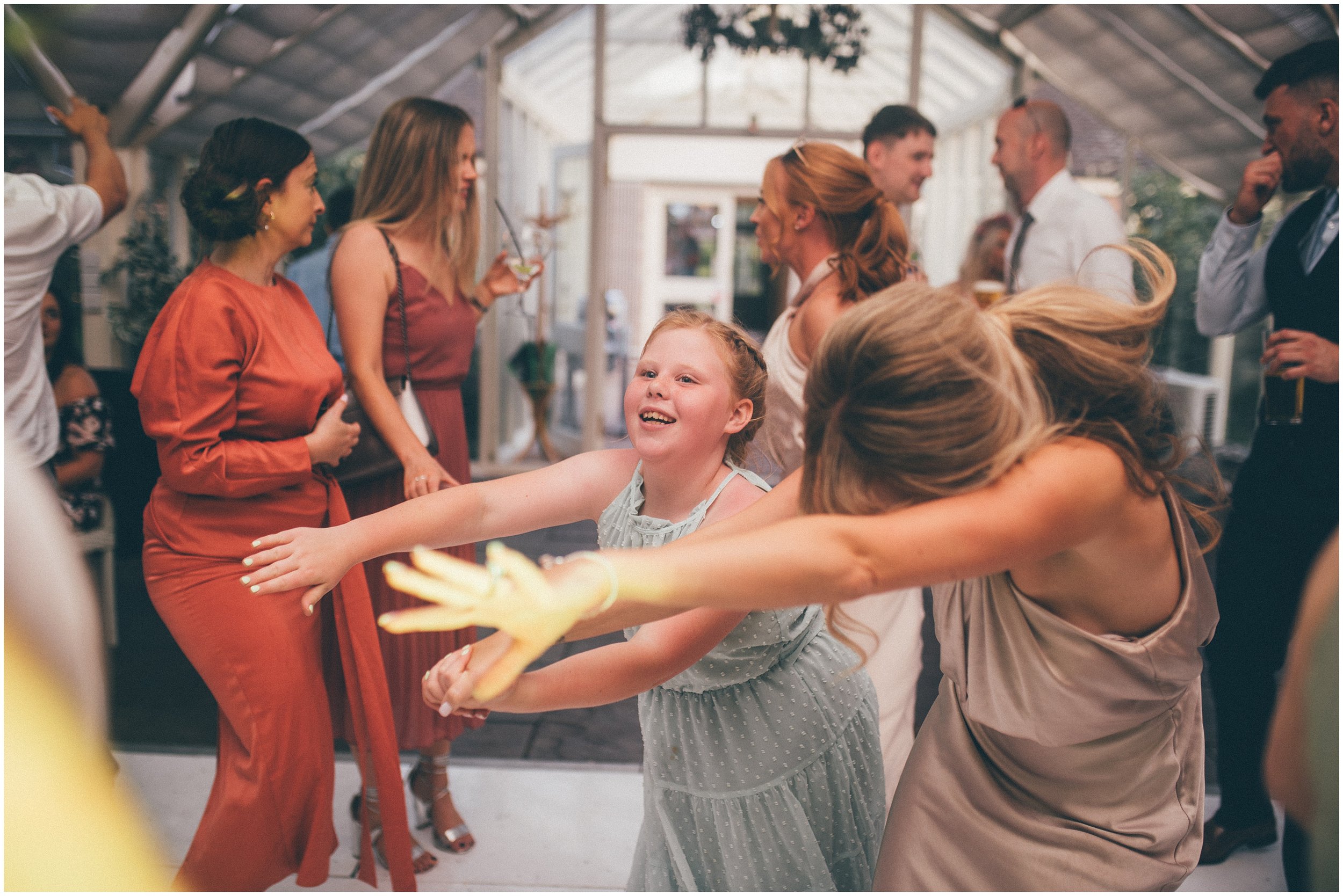 Wedding Guests enjoy the dancefloor at Abbeywood Estate wedding venue in Delamere, Cheshire.