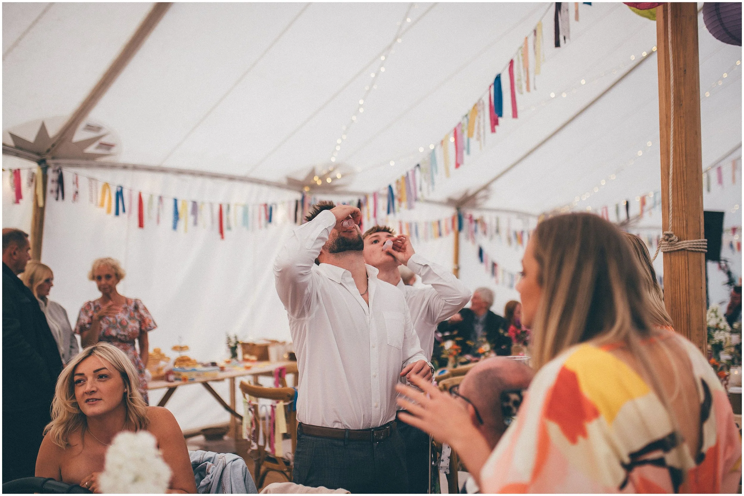 Guests do shots at Wedfest at Garden marquee in North Wales