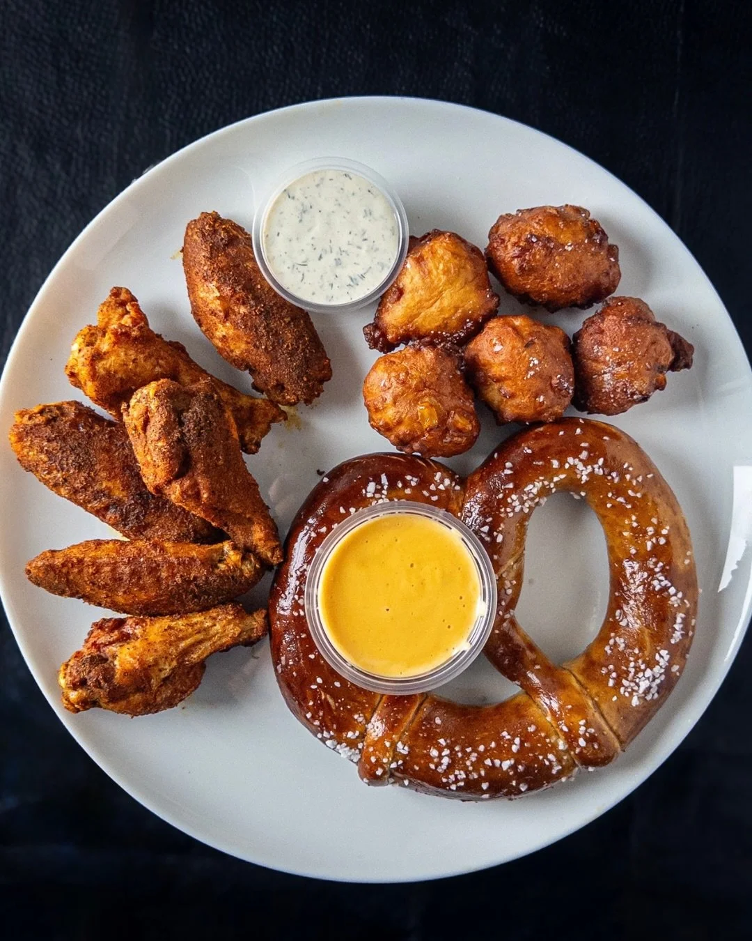 Super Bowl Sunday Special:
SUPER SNACK PLATE 
House pretzel with beer cheese, five corn fritters, and six wings with choice of flavor: sriracha buffalo, fireside spice dry rub, or lemon Thai pepper dry rub. 

Super Snack Plate available tomorrow only