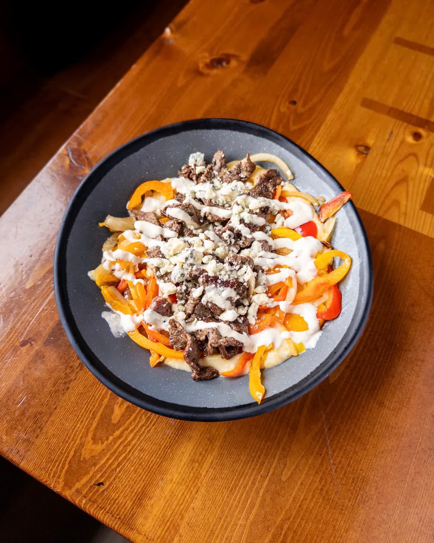 GRILLED STEAK BREAKFAST GRITS
creamy stone-ground grits topped with grilled marinated flank steak, grilled onions and peppers, horseradish sauce, and blue cheese crumbles. 

Grilled Steal Breakfast Grits available during brunch every Saturday and Sun