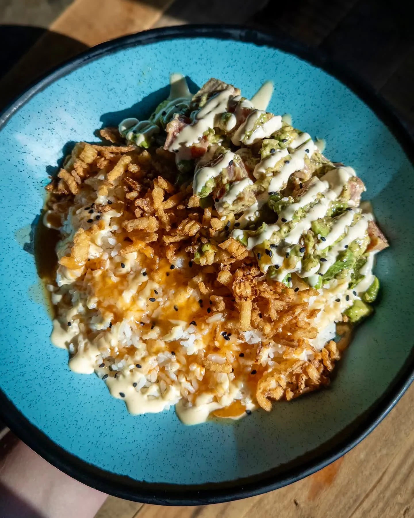 TUNA POKE BOWL
seared ahi tuna, edamame, and avocado in a passionfruit sauce with crispy onions and sesame seeds topped with yum yum and mango sriracha on white rice. 
Pair with TROPICAL SAUCE, Fruited Sour available on draft and in 16oz cans to-go. 