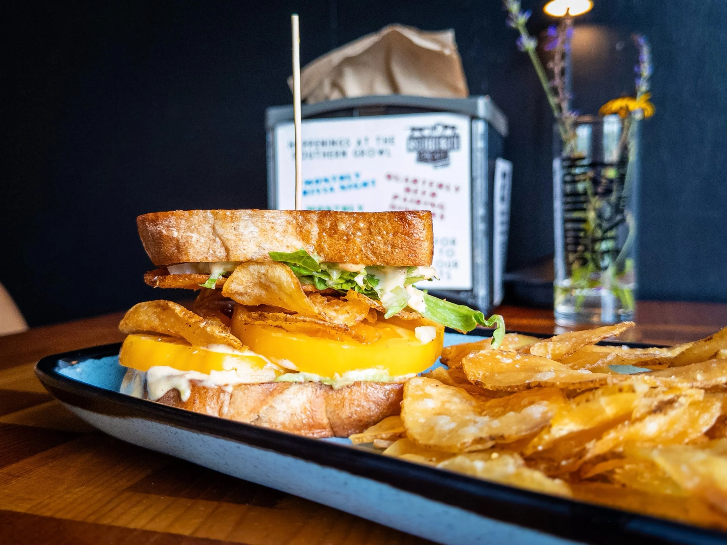 TSG TOMATO SANDWICH 
heirloom tomatoes, vegan smoked corn aioli, avocado, lettuce, and bbq chips on sliced house wheat bread. 
Pair with SOUTHERN SANCTUM, American Tripel available on draft and in 16oz cans to-go. 

TSG Tomato Sandwich available now 