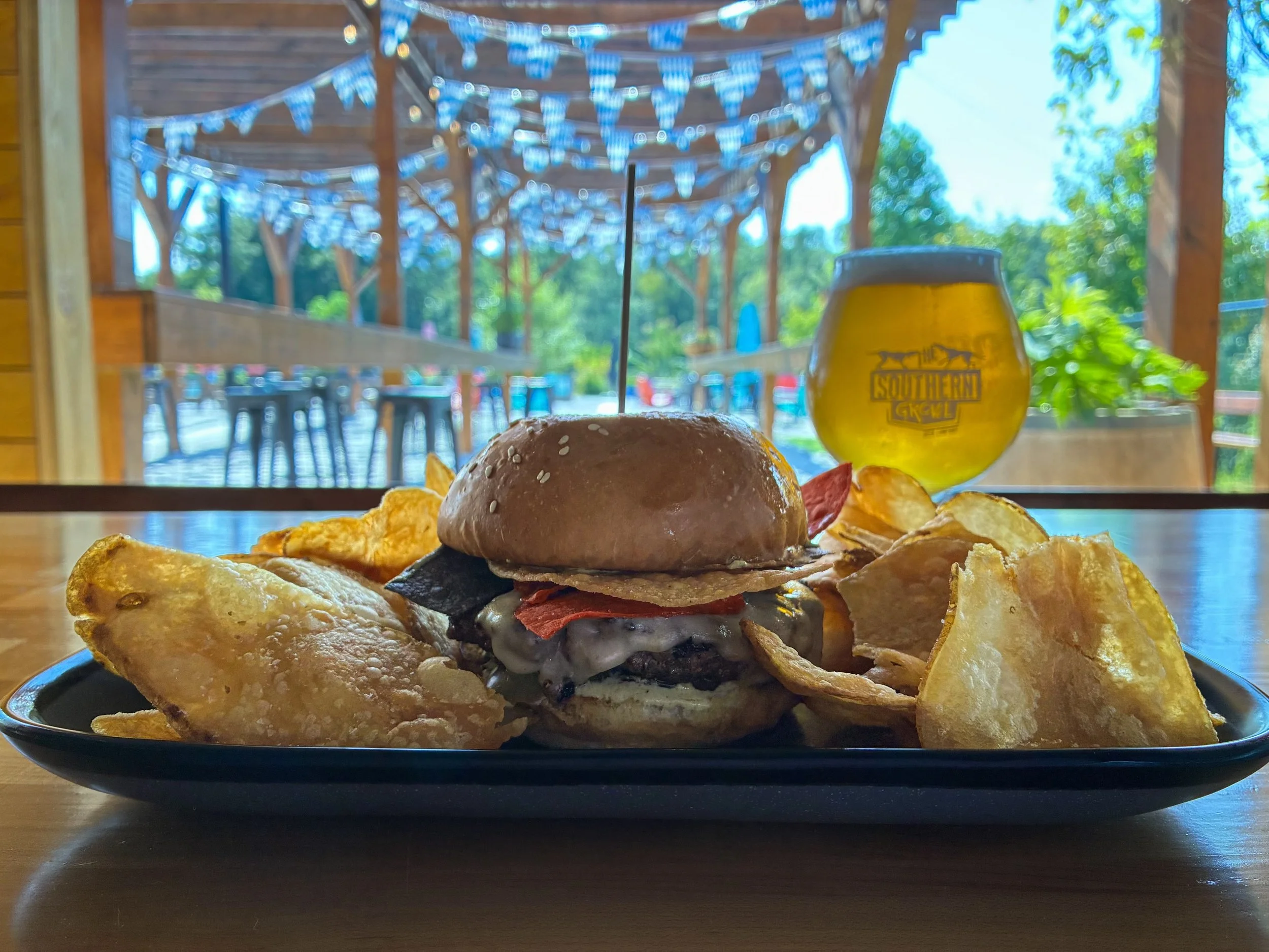 SALT N PEPPA BURGER
Topped with pepper jack cheese, poblano spread,  chili-lime salt tortilla chips and cherry peppers on a house sesame bun.
Pair with TIKI TAILWAGGER, southern IPA with passion fruit, orange, and guava. Available on draft and 16oz c