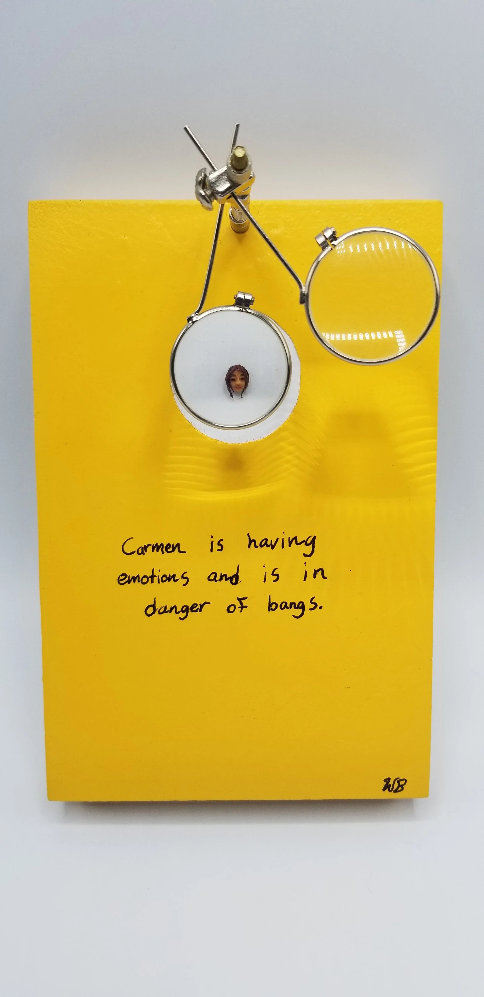 “Carmen,” Polymer clay, jeweler’s loupe, ink, acrylic on birch wood panel, $200