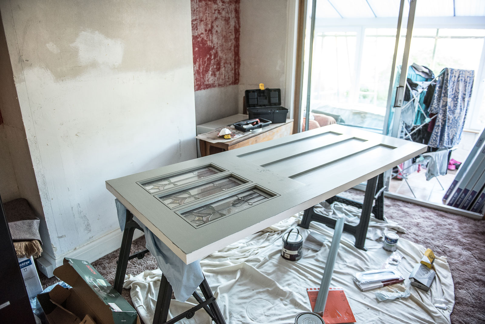 New front door being sanded and painted in our dining room