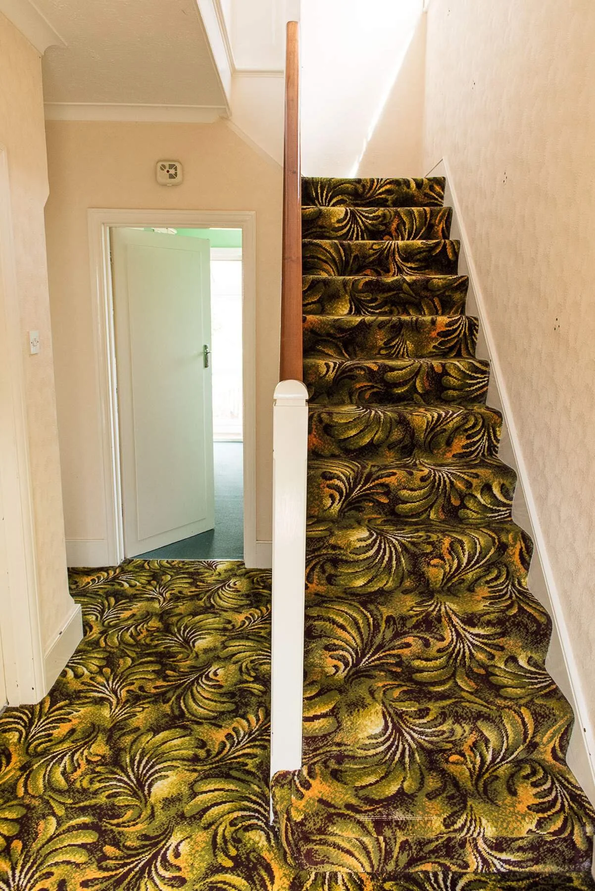 Before image of carpeted staircase in cottage