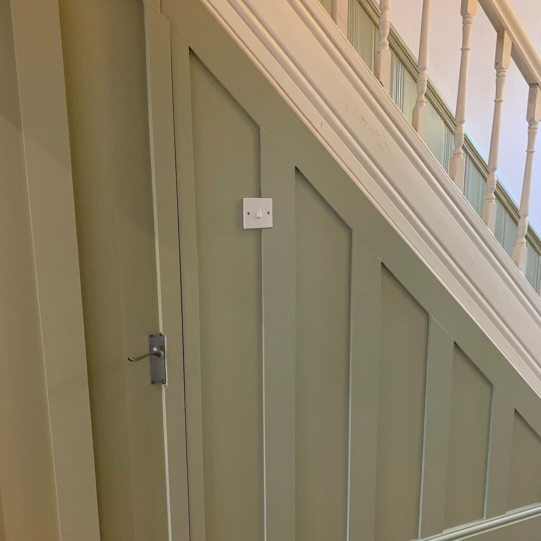 Under stairs storage cupboard behind panelling - IMAGE: @edwardian_obsession
