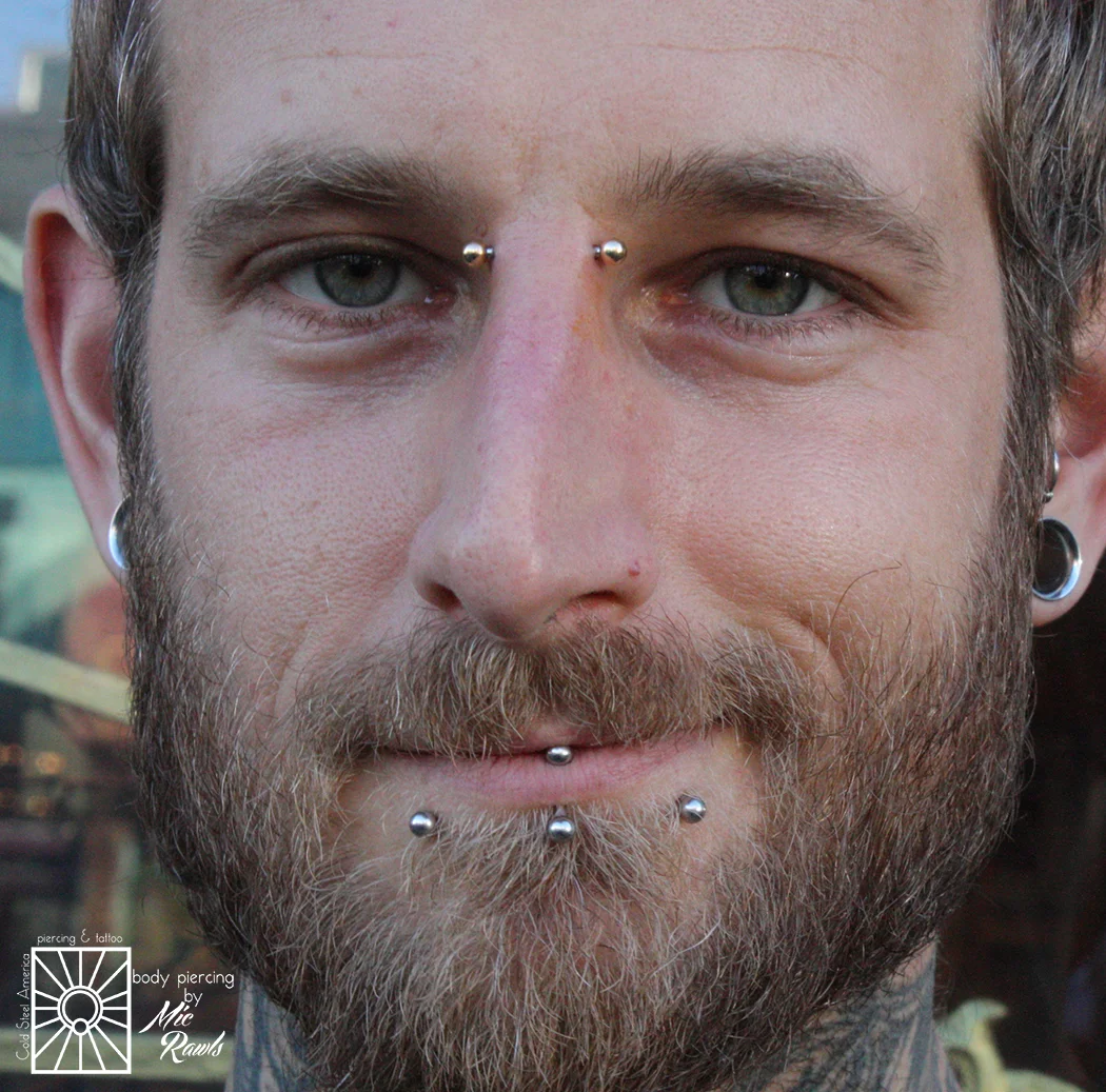 We added this nose bridge piercing to this handsome client's collection and it looks so good on him! 12g (2mm) implant-grade steel barbell post with 4mm solid 14 karat Yellow Gold balls from Body Vision Los Angeles.