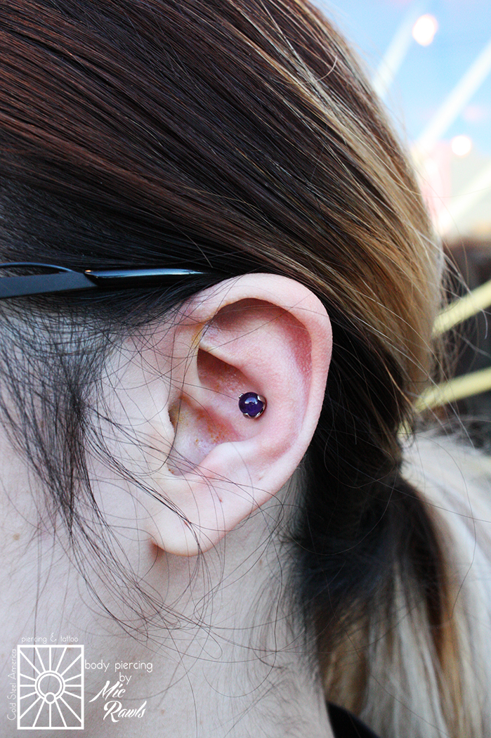Fresh conch piercing, done at 14g, wearing a 5mm prong-set Amethyst from Industrial Strength. Natural stone pieces look so amazing in these piercings!