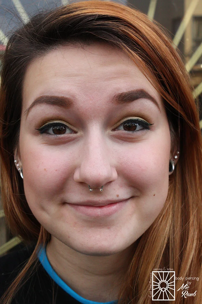 Fresh septum piercing wearing a 16g (1.2mm) implant-grade steel circular barbell with 2mm synthetic Bubblegum Pink Opals from Industrial Strength.