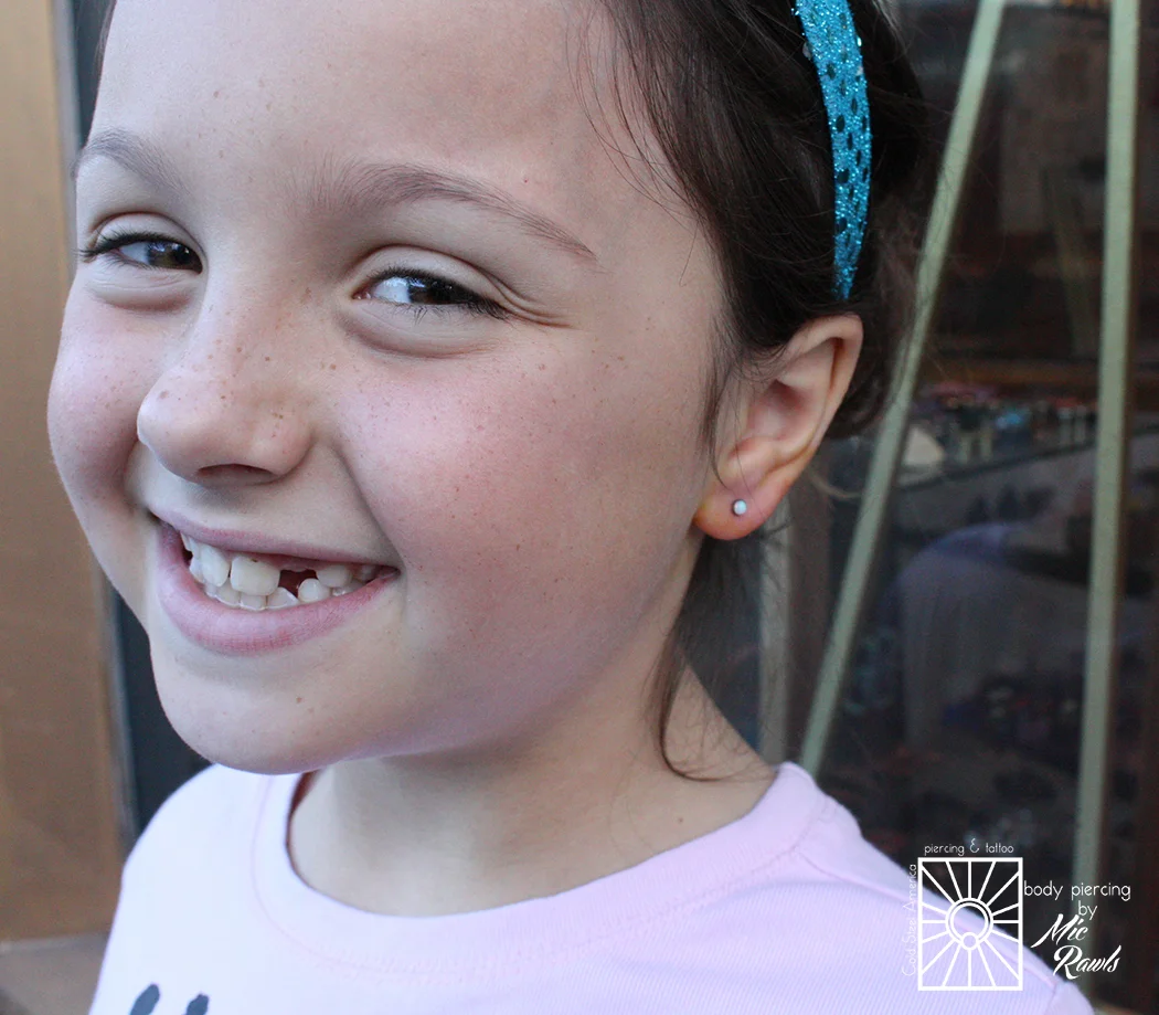 This little cutie was so awesome when she came in to have her earlobes pierced for the first time! So ready, so fun, and she picked out these beautiful 3mm synthetic White Opals from NeoMetal and they look so great on her. Remember folks: just say no to piercing guns!