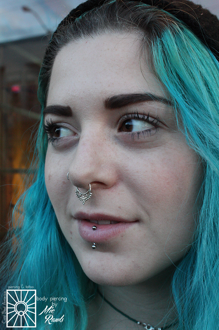 Fresh vertical labret piercing wearing a 16g (1.2mm) implant-grade titanium push-pin curved barbell from NeoMetal.