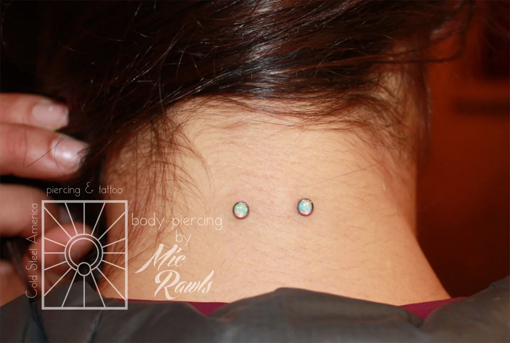 Well-healed nape piercing, she came in to upgrade the gems to these cute 4mm cabochon synthetic White Opals from Industrial Strength!
