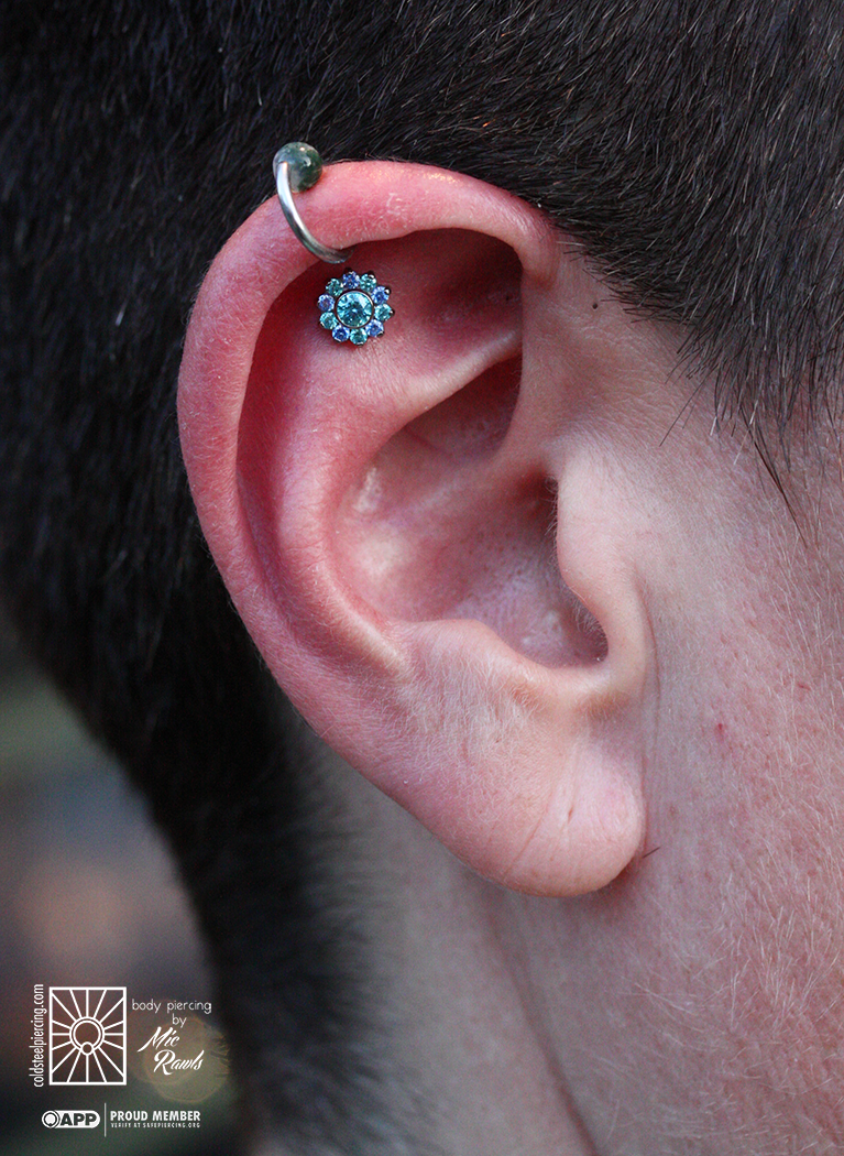Fresh helix piercing wearing a stunning titanium “Odyssey” flower end from Industrial Strength! Those alternating Arctic Blue and Mint Green cz’s make such a great color combination, and the sparkle on this piece is just amazing.