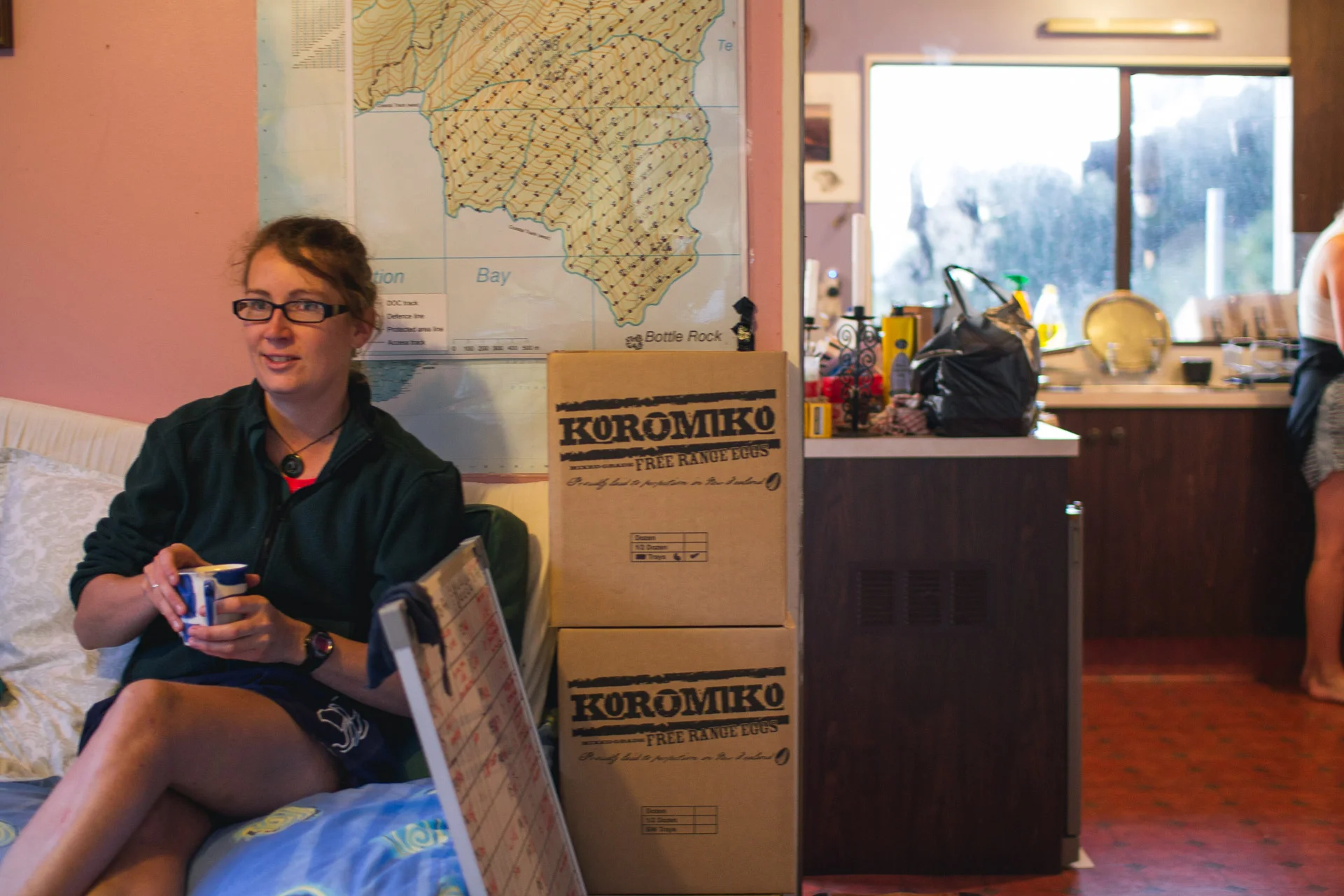The writer re-caffeinates in preparation for the day ahead... The boxes of eggs to her left were generously donated to ZIP by Koromiko Free Range Eggs for use in our stoat traps.